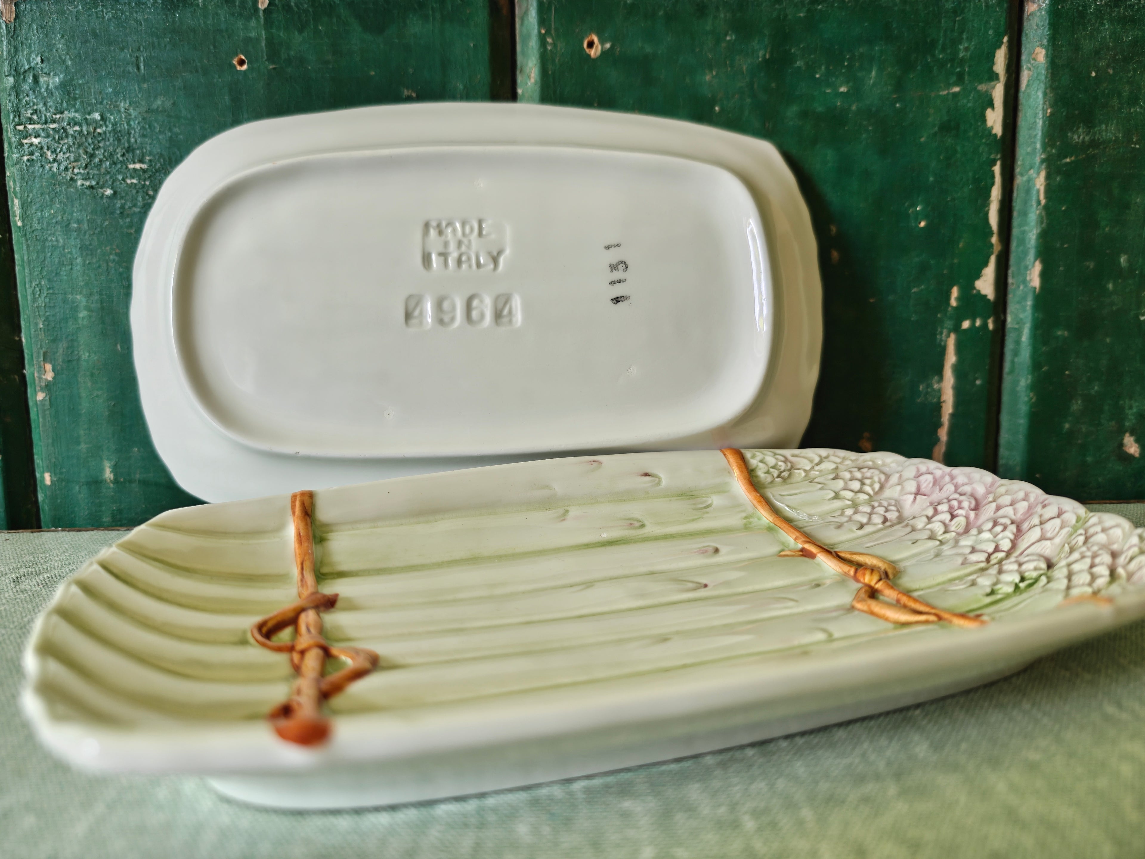 Side view and back view of two ceramic asparagus dishes