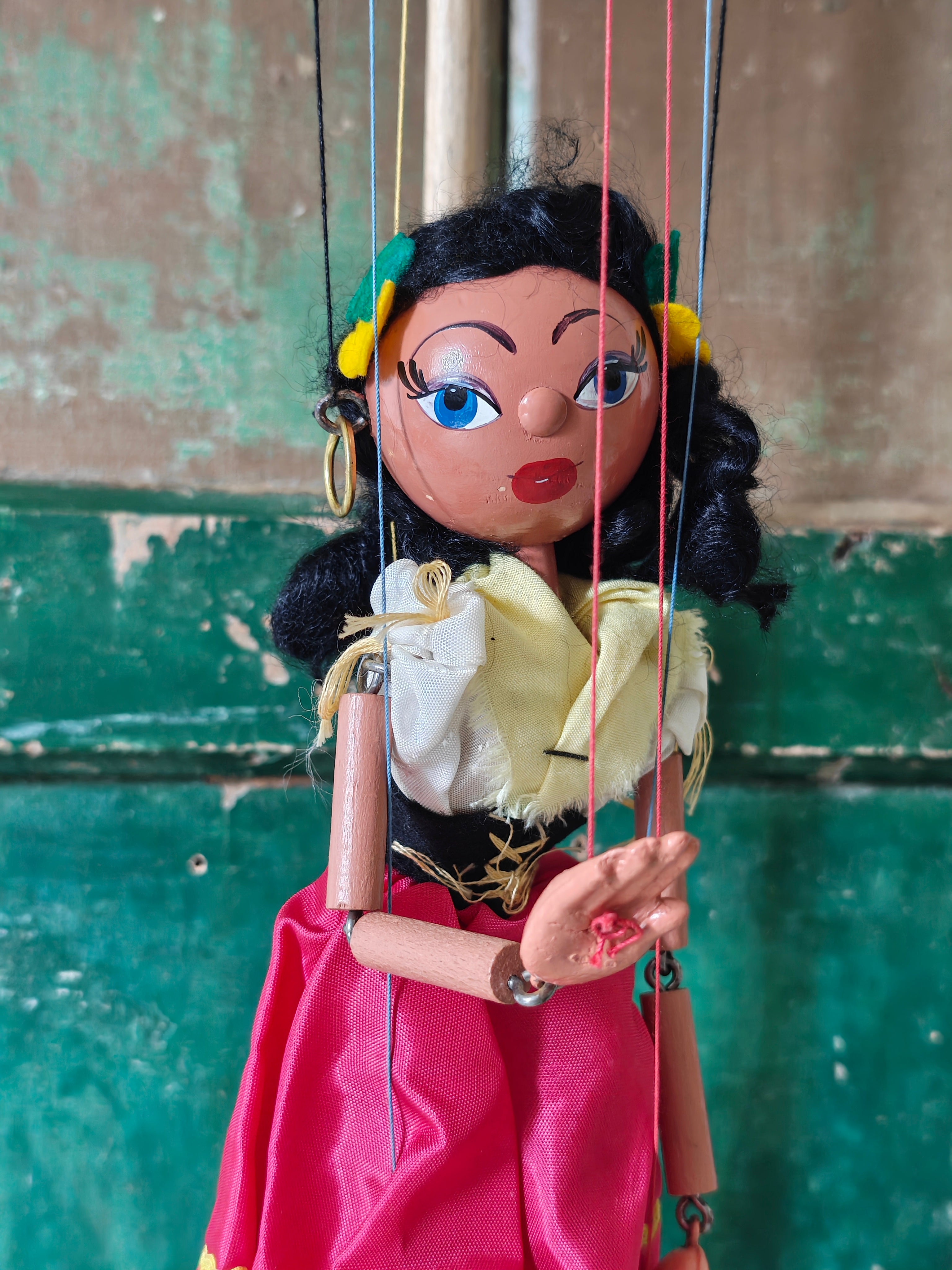 String puppet with black hair and pink dress 