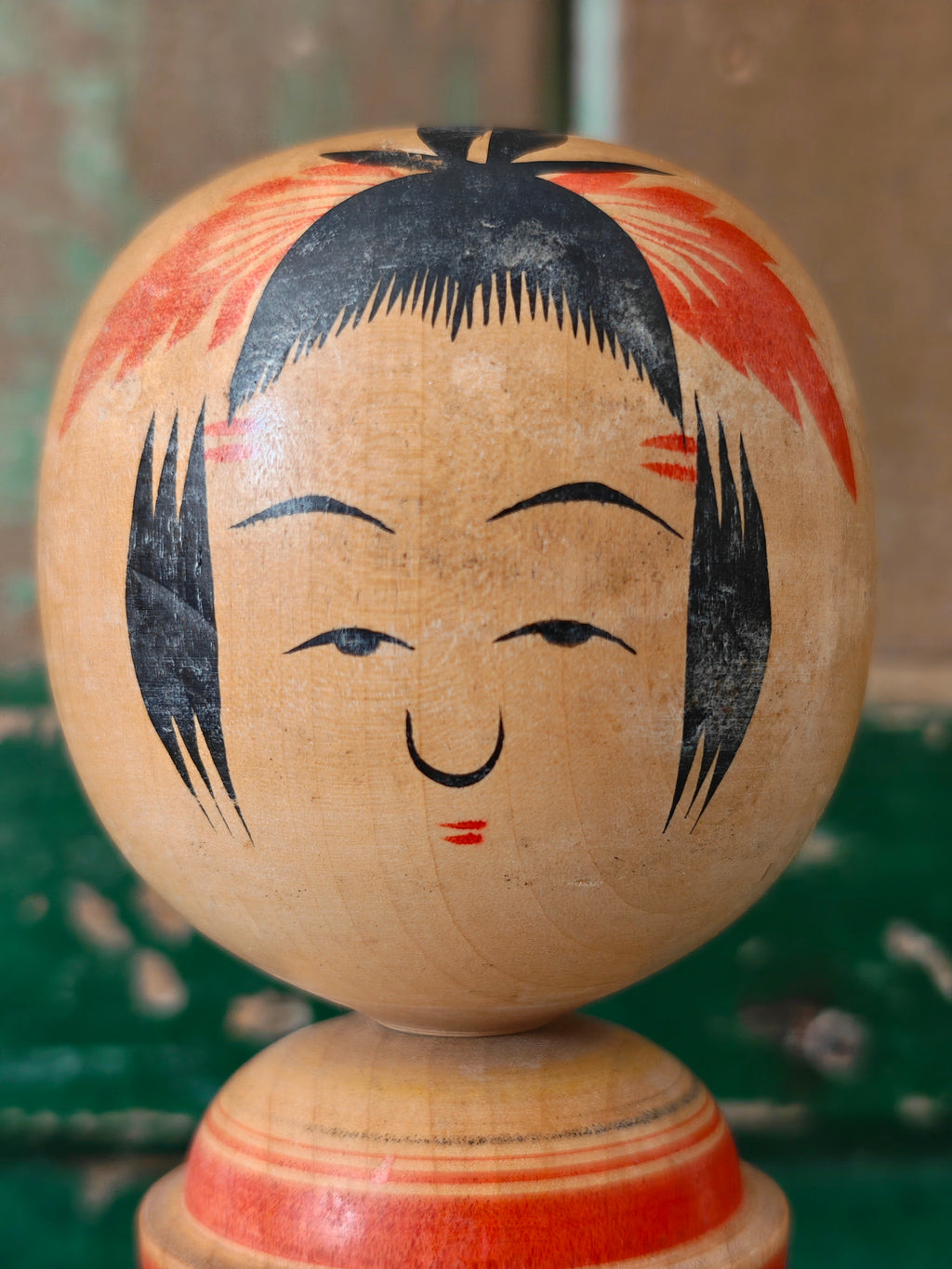 Close-up of a kokeshi doll showing face detail