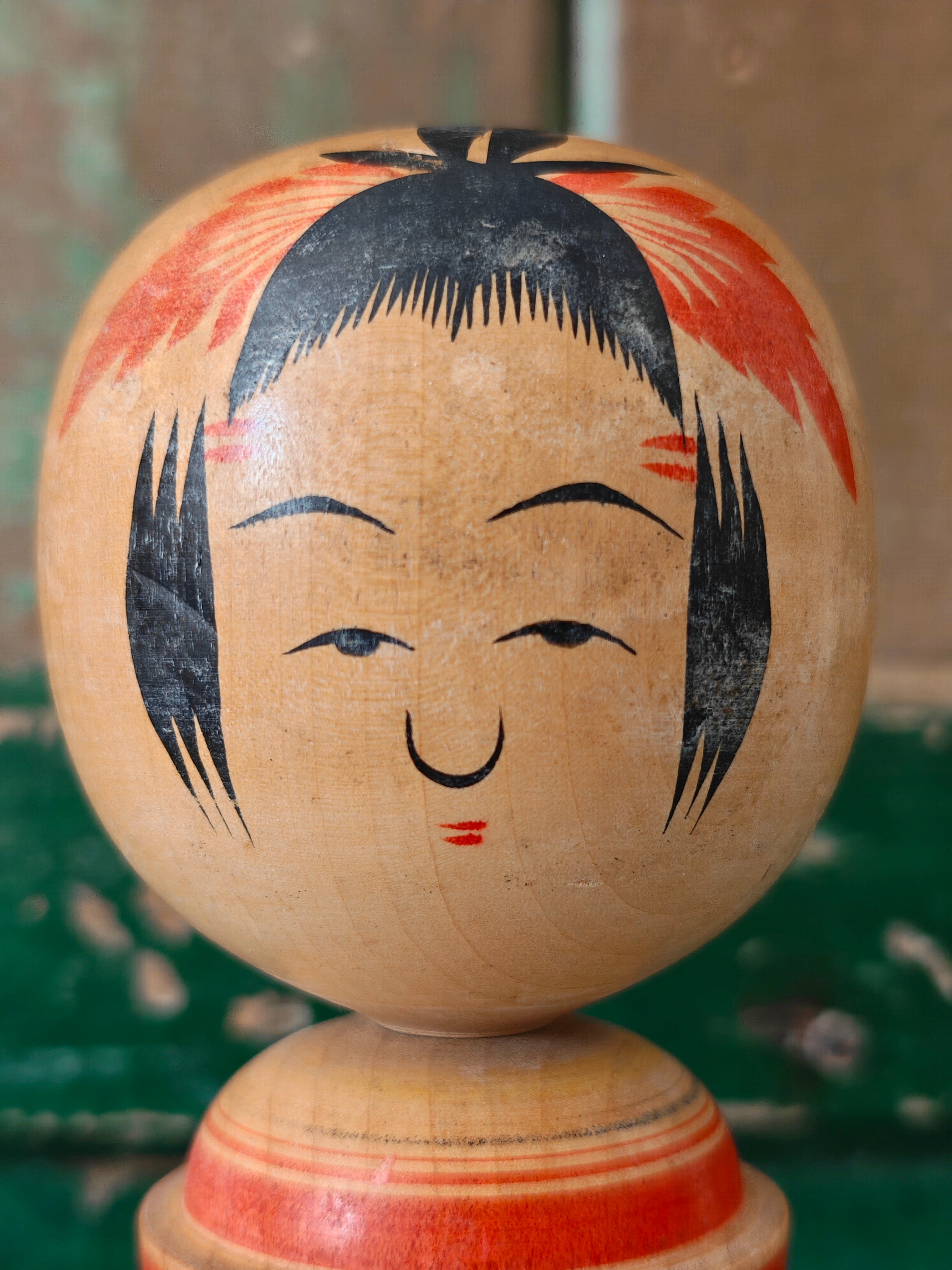 Close-up of a kokeshi doll showing face detail
