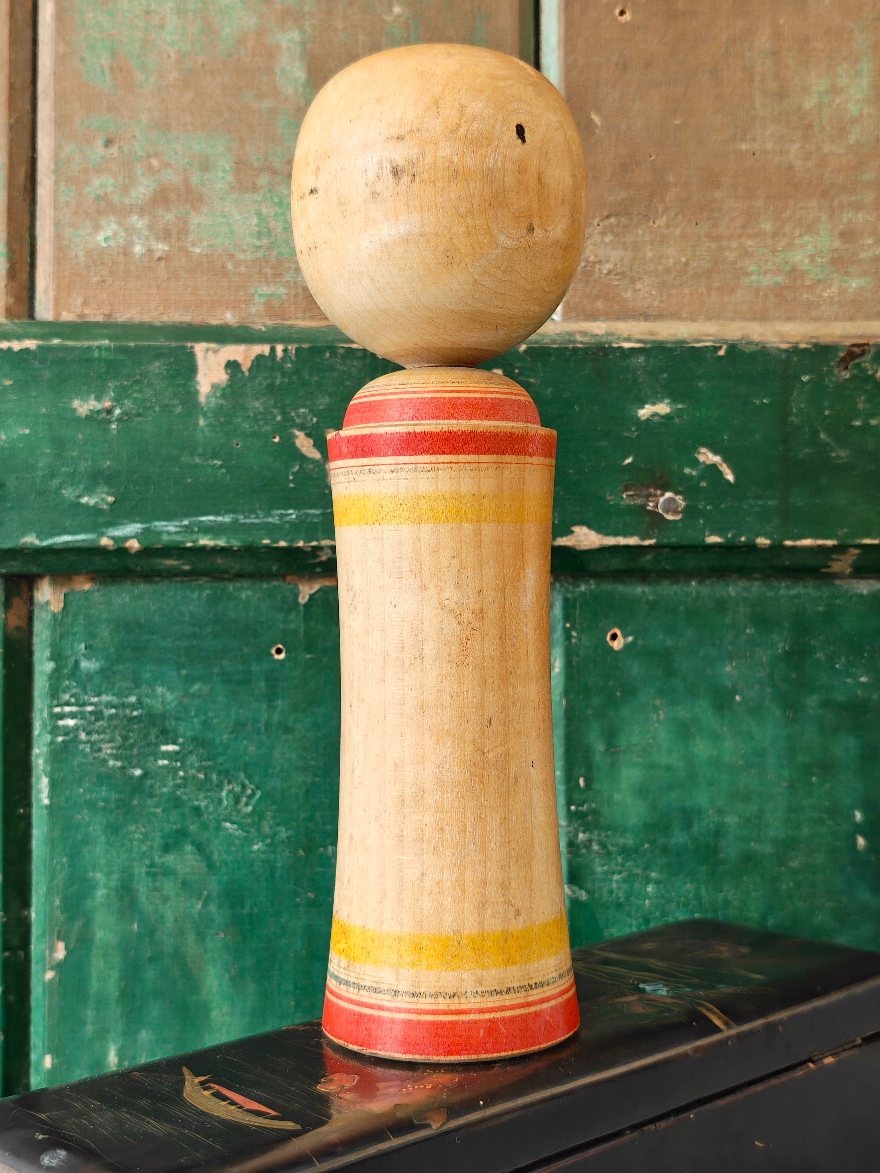 Hand painted decoration of a Kokeshi doll