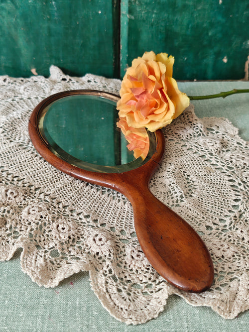 Antique wooden oval hand mirror 