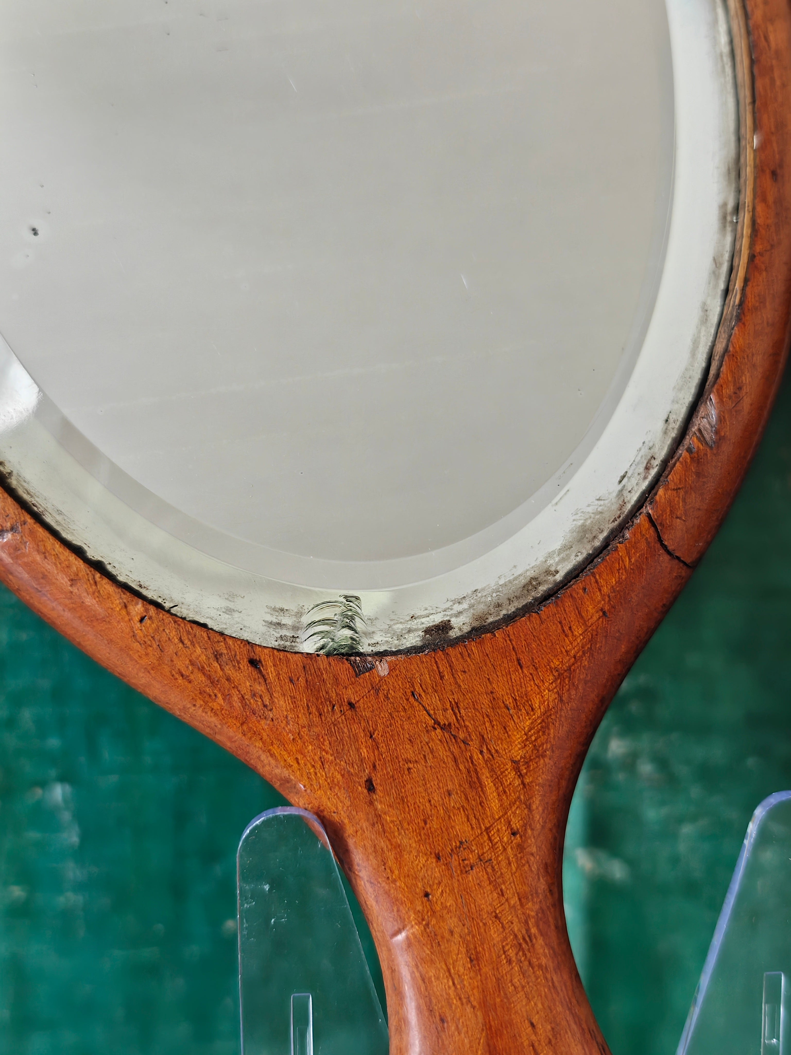 Close-up of an antique wooden oval hand mirror 