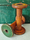 Two vintage wooden spools with traces of paint