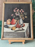 Framed still life painting with fruits and flowers on a table.