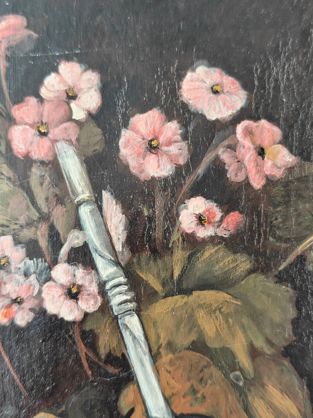 Close-up of a painting showing pink flowers on a dark background