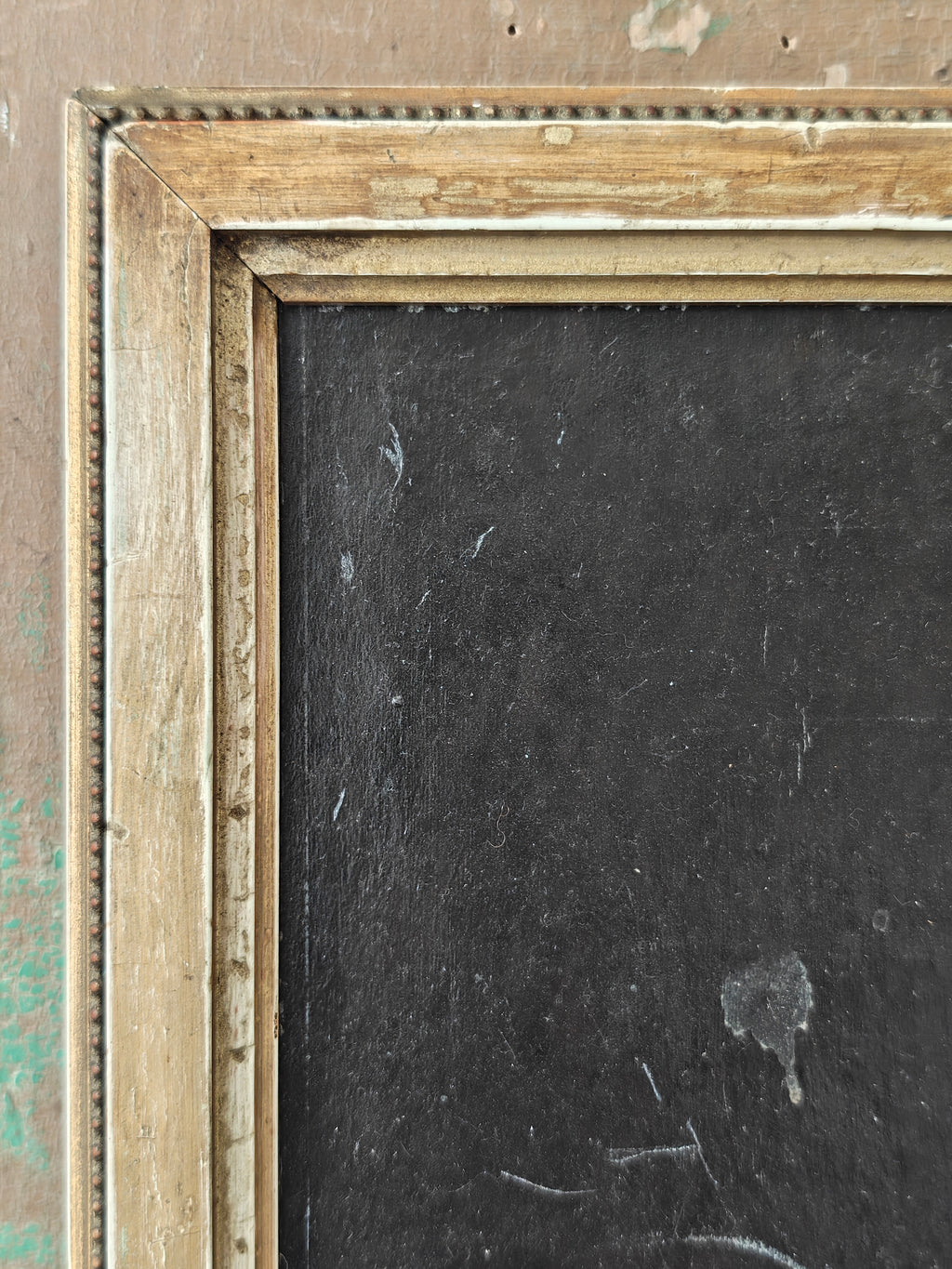 Close-up of a wooden picture frame with a dark interior background