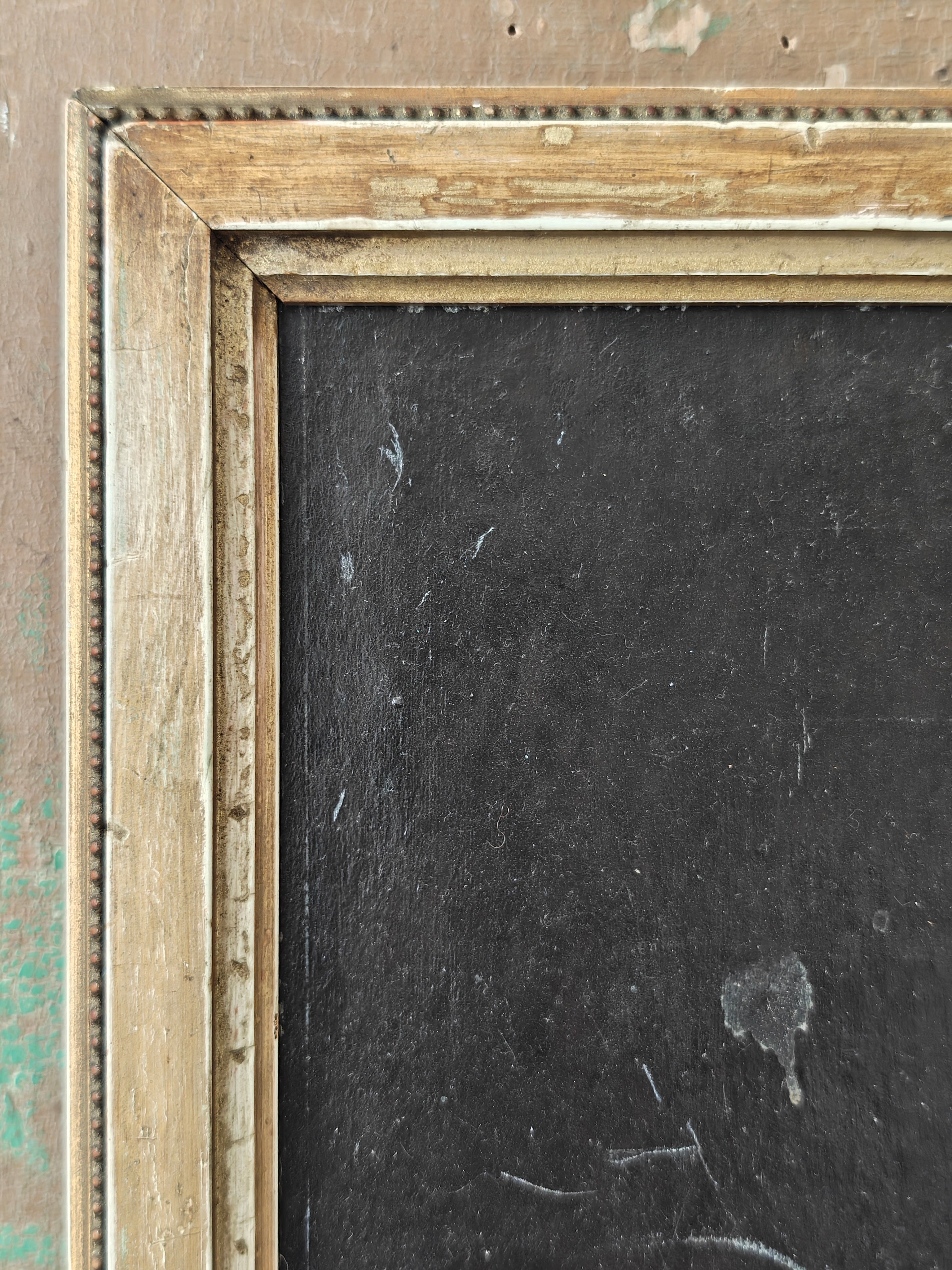 Close-up of a wooden picture frame with a dark interior background