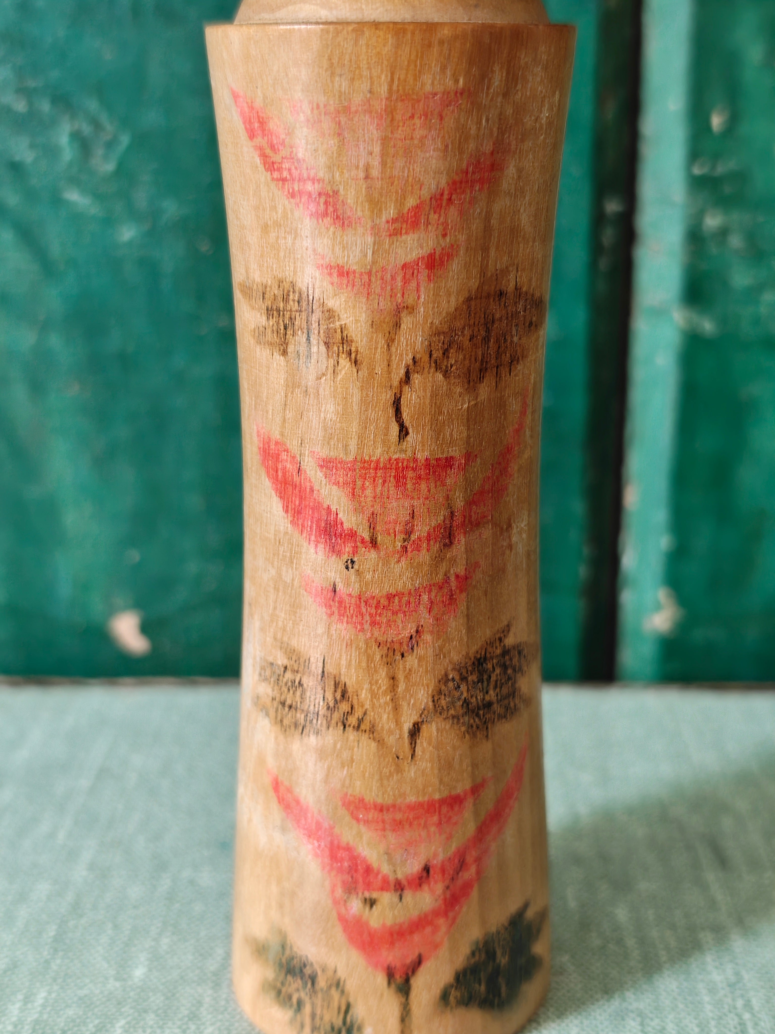 Close-up of vintage wooden kokeshi doll with traditional design