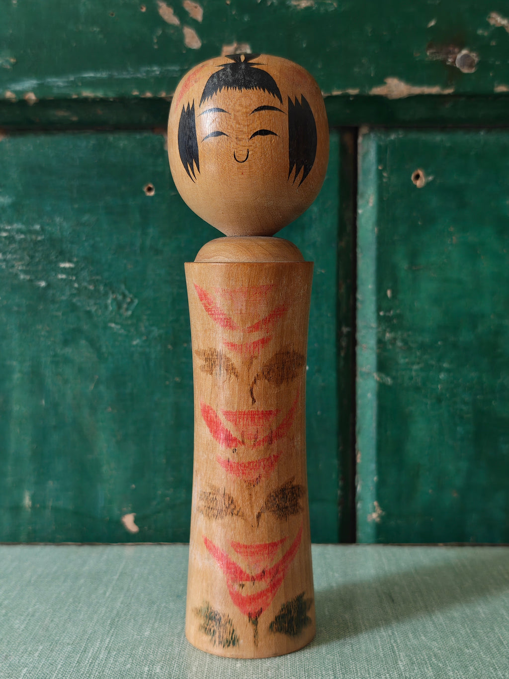 Vintage wooden kokeshi doll with traditional design