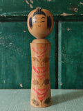 Vintage wooden kokeshi doll with traditional design