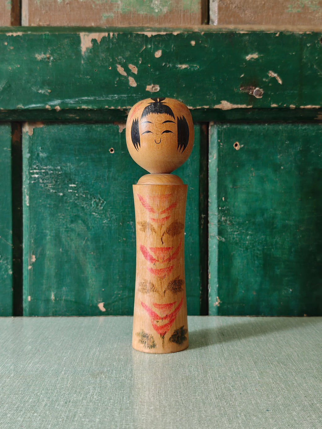 Vintage wooden kokeshi doll with traditional design