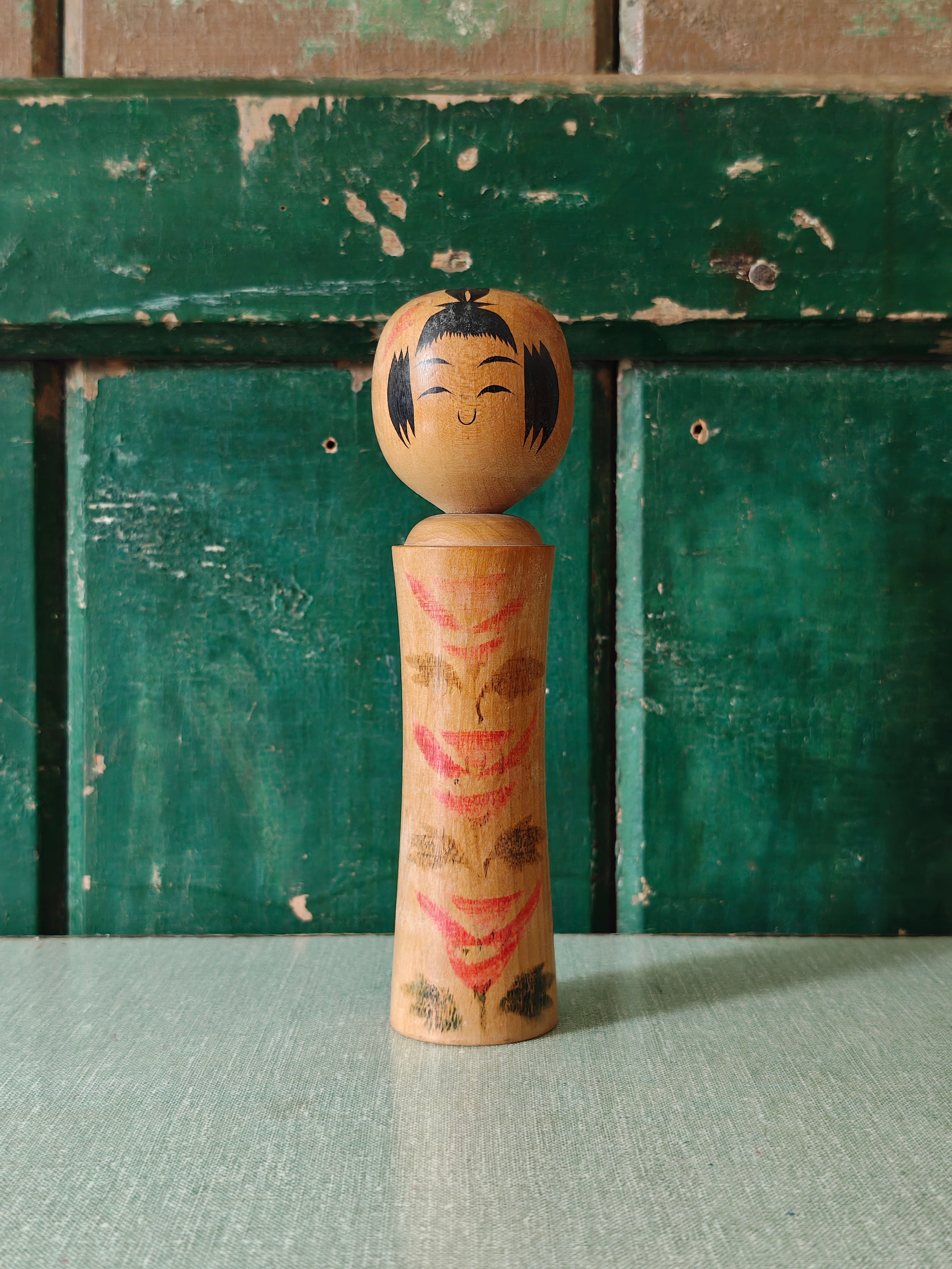 Vintage wooden kokeshi doll with traditional design