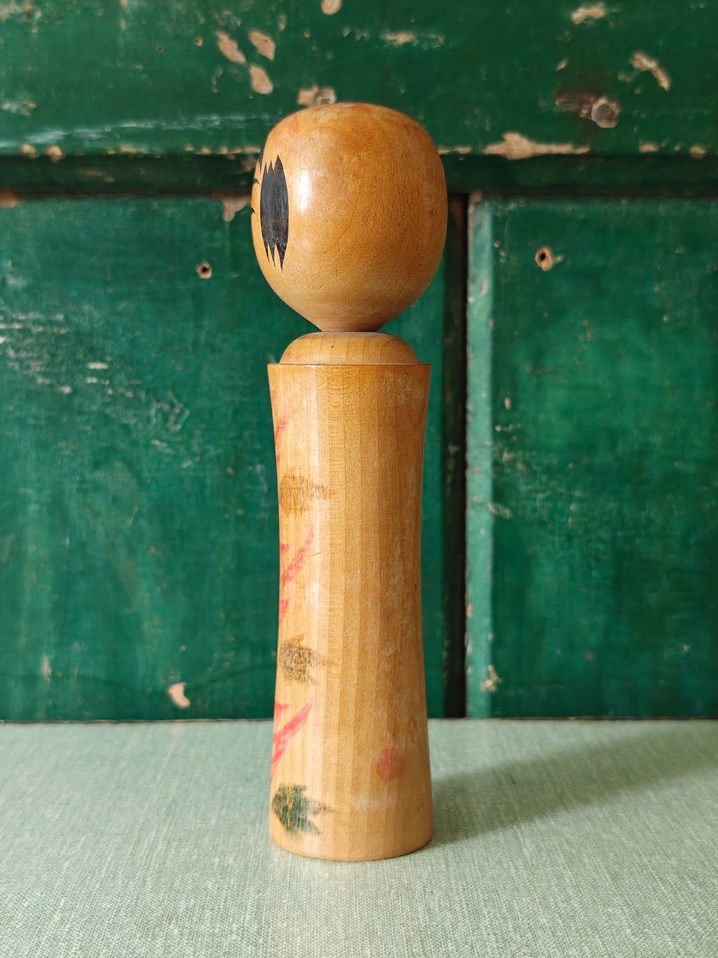 Vintage wooden kokeshi doll with traditional design