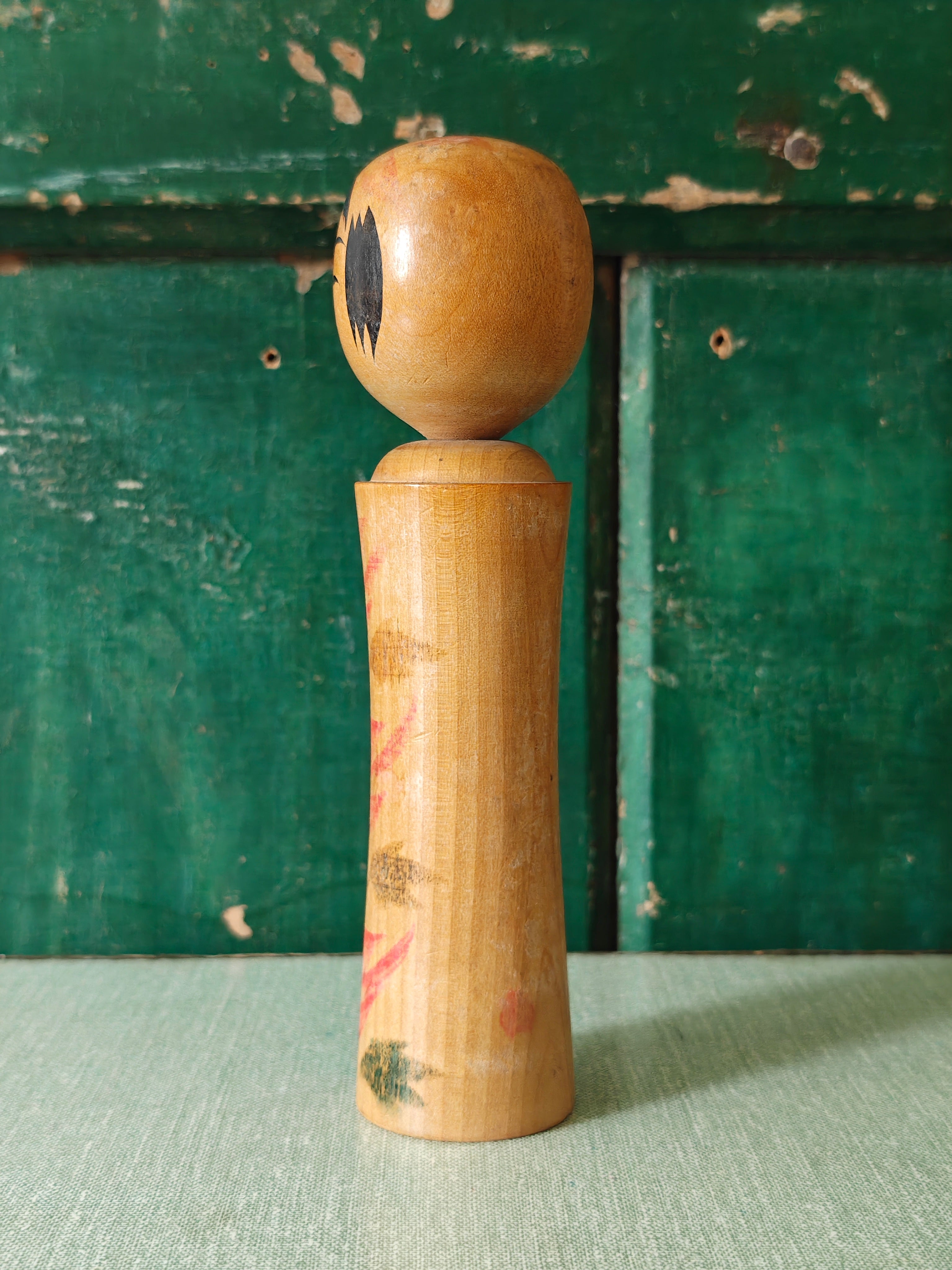 Vintage wooden kokeshi doll with traditional design