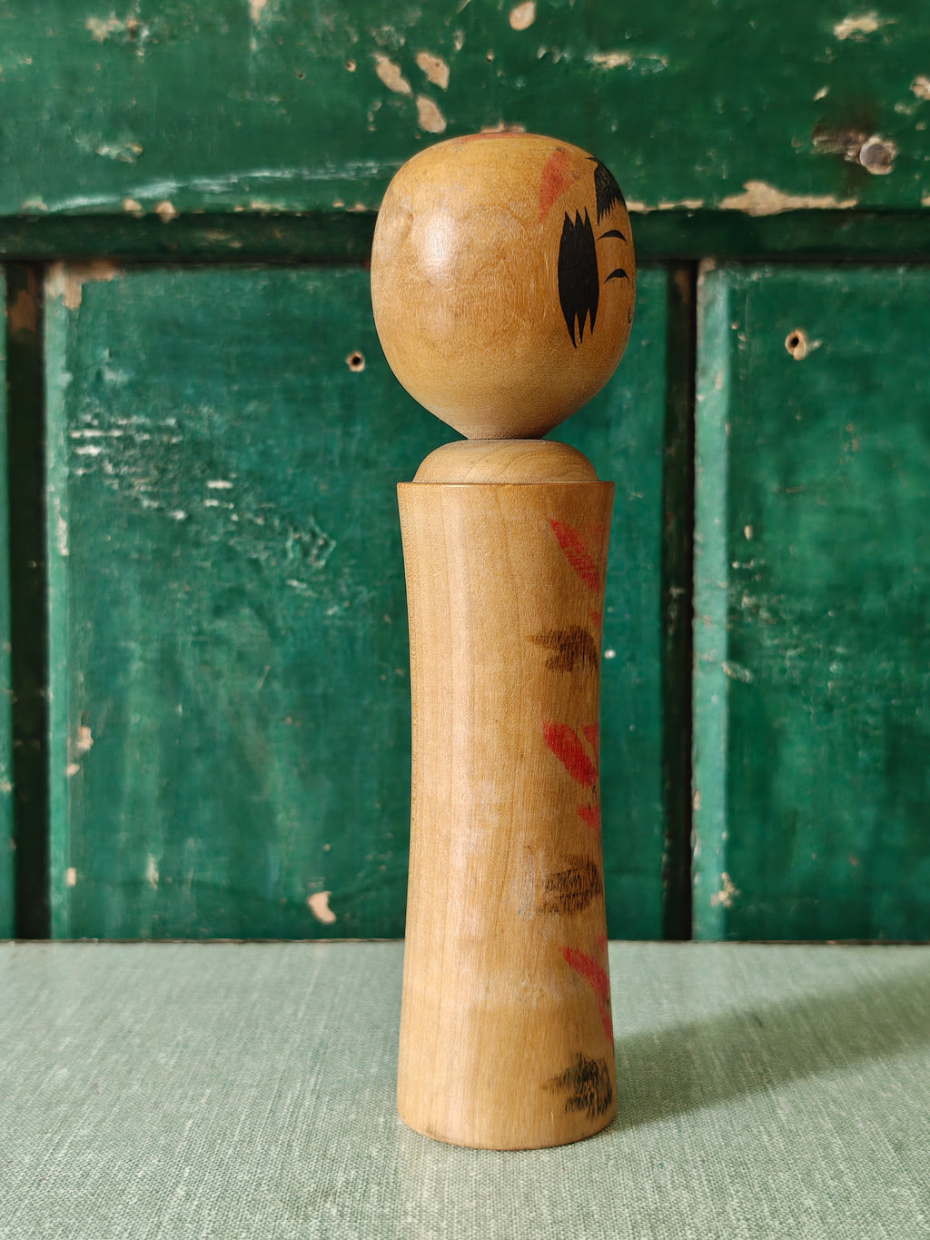 Vintage wooden kokeshi doll with traditional design