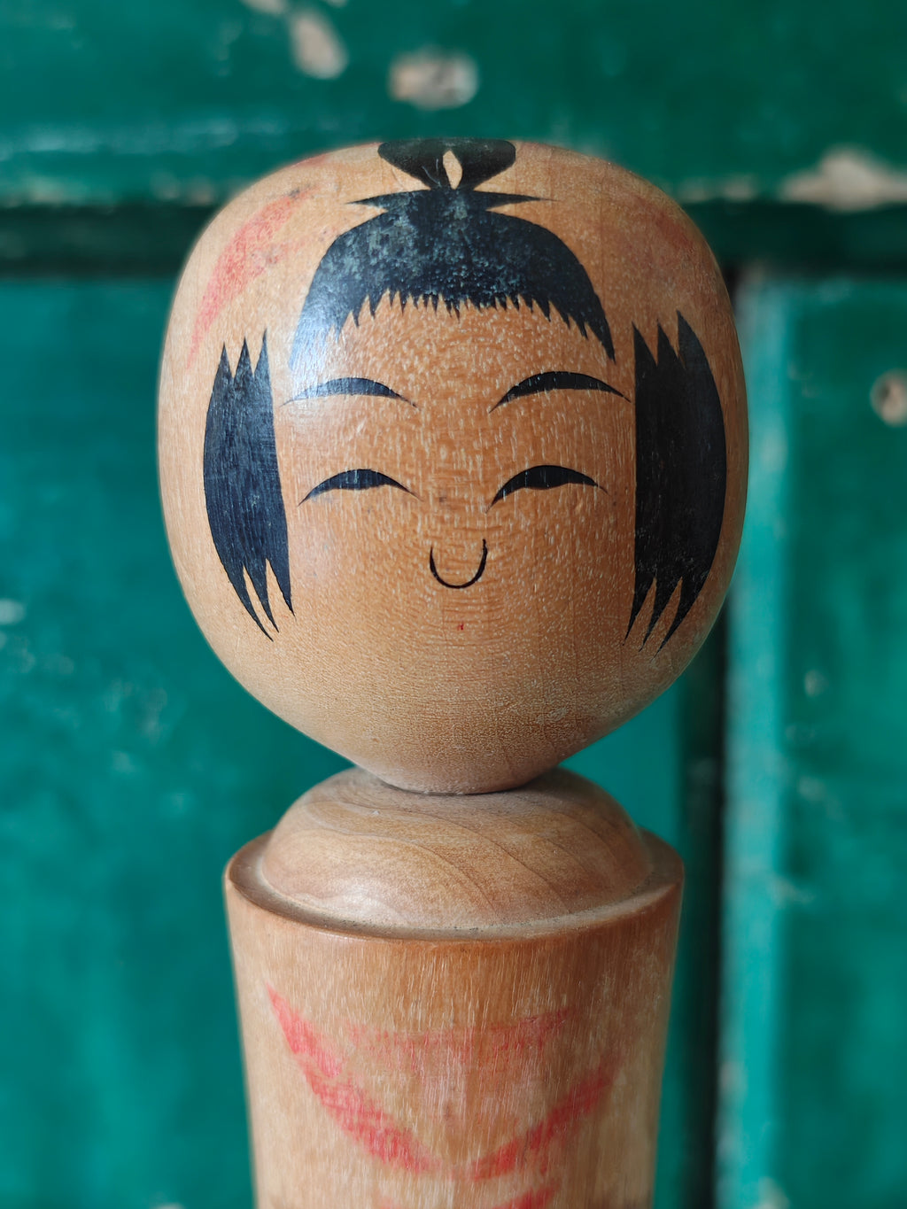 Close-up of the face of a wooden kokeshi doll 