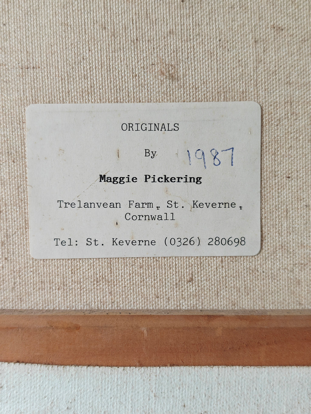 Label showing artist's details on the back of a canvas