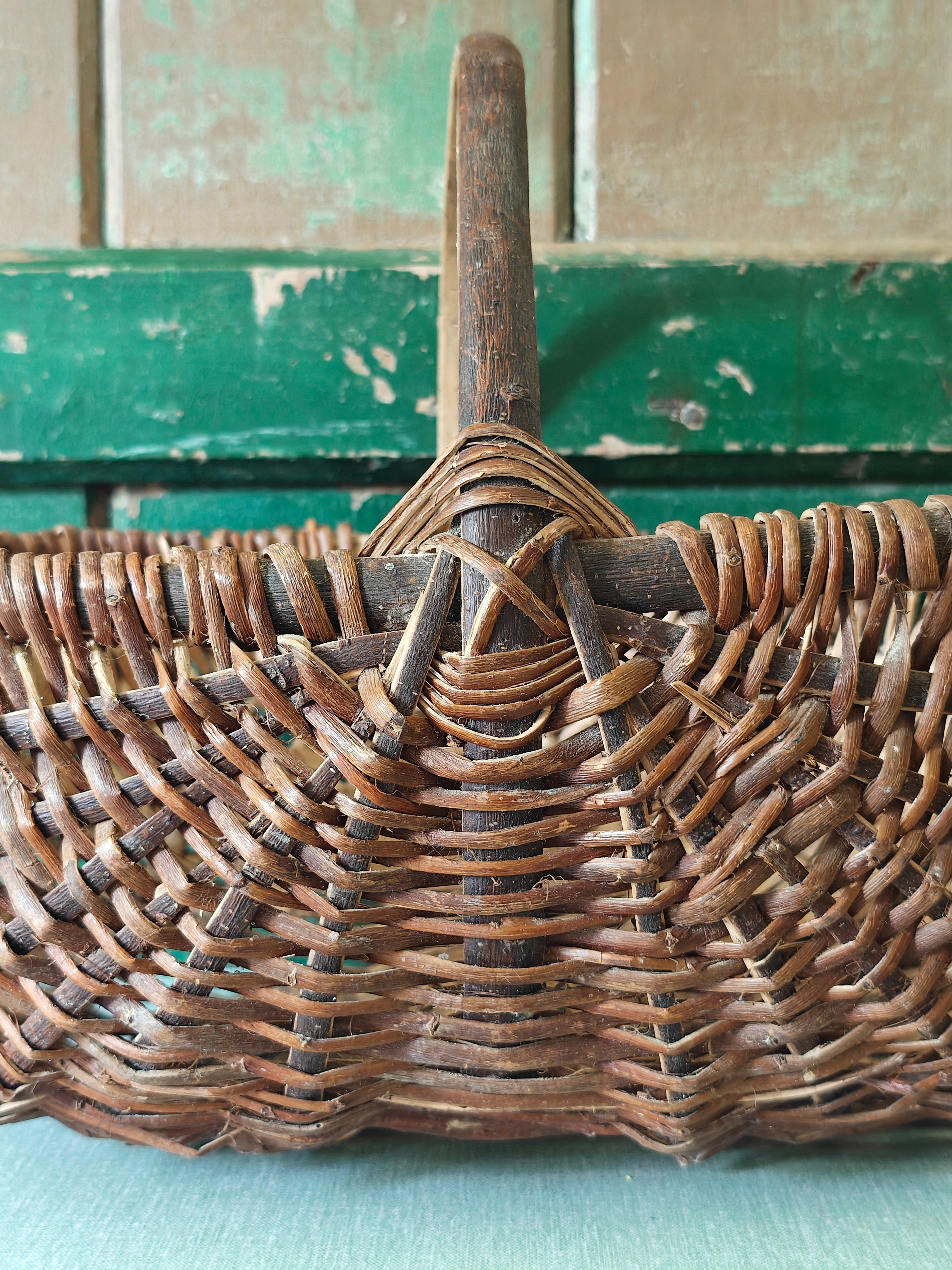 Close-up of a wicker basket with a wooden handle