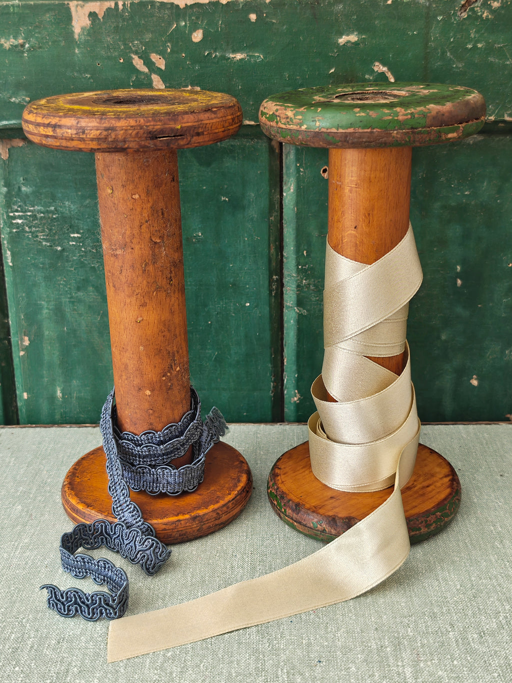 Two vintage wooden spools with traces of paint