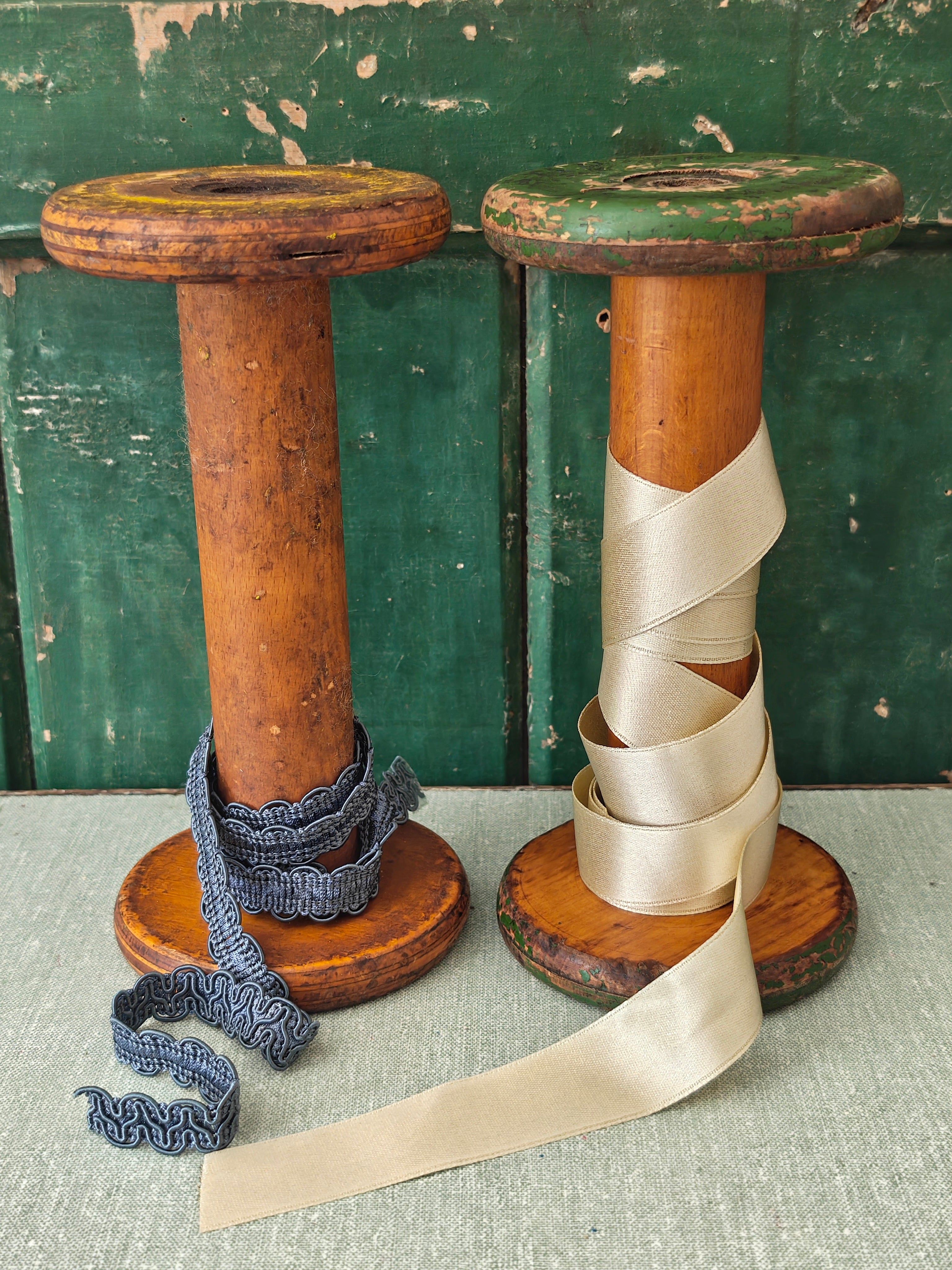 Two vintage wooden spools with traces of paint