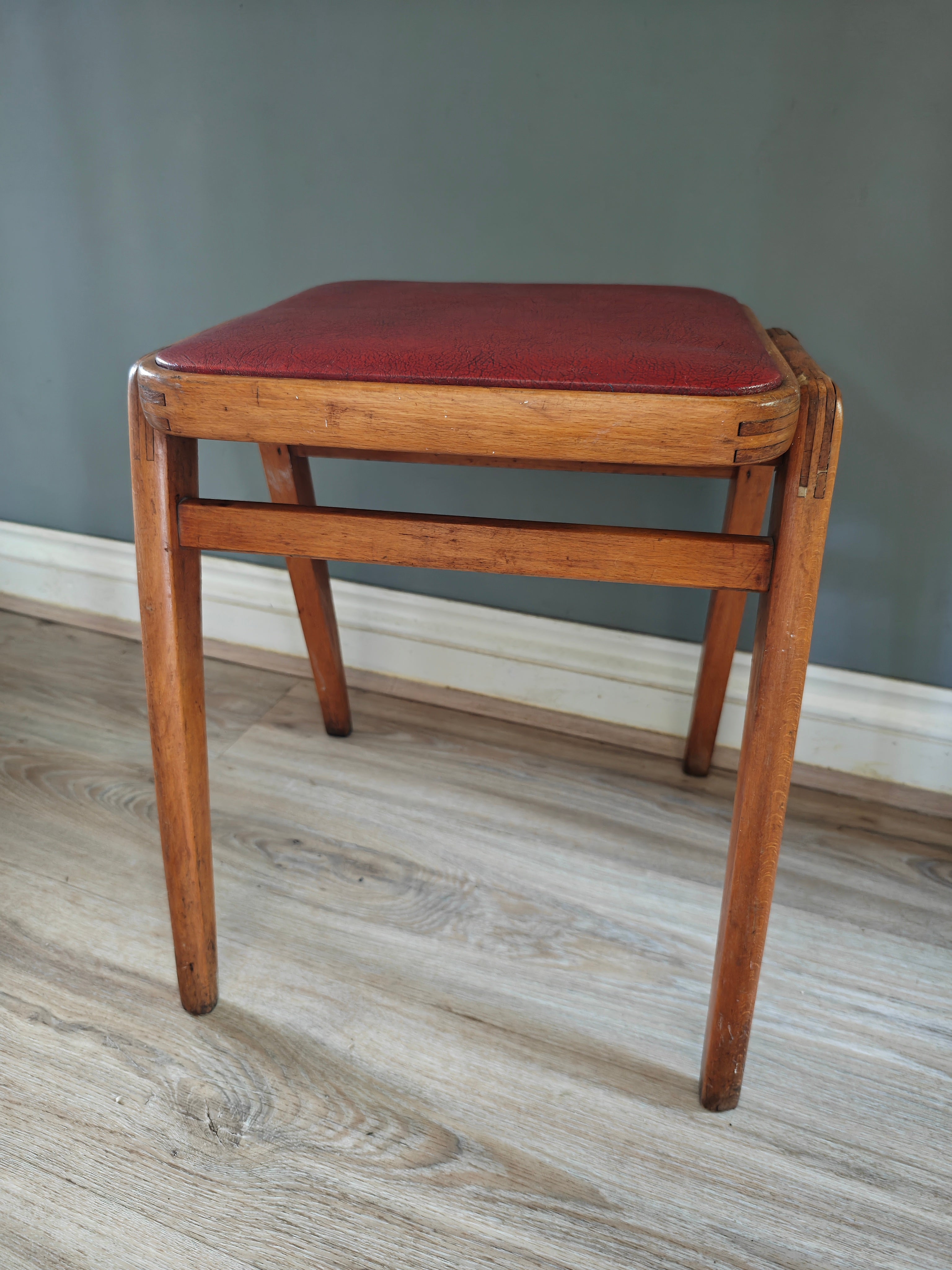 Mid-century wood frame stool with red vinyl seat