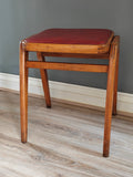 Mid-century wood frame stool with red vinyl seat