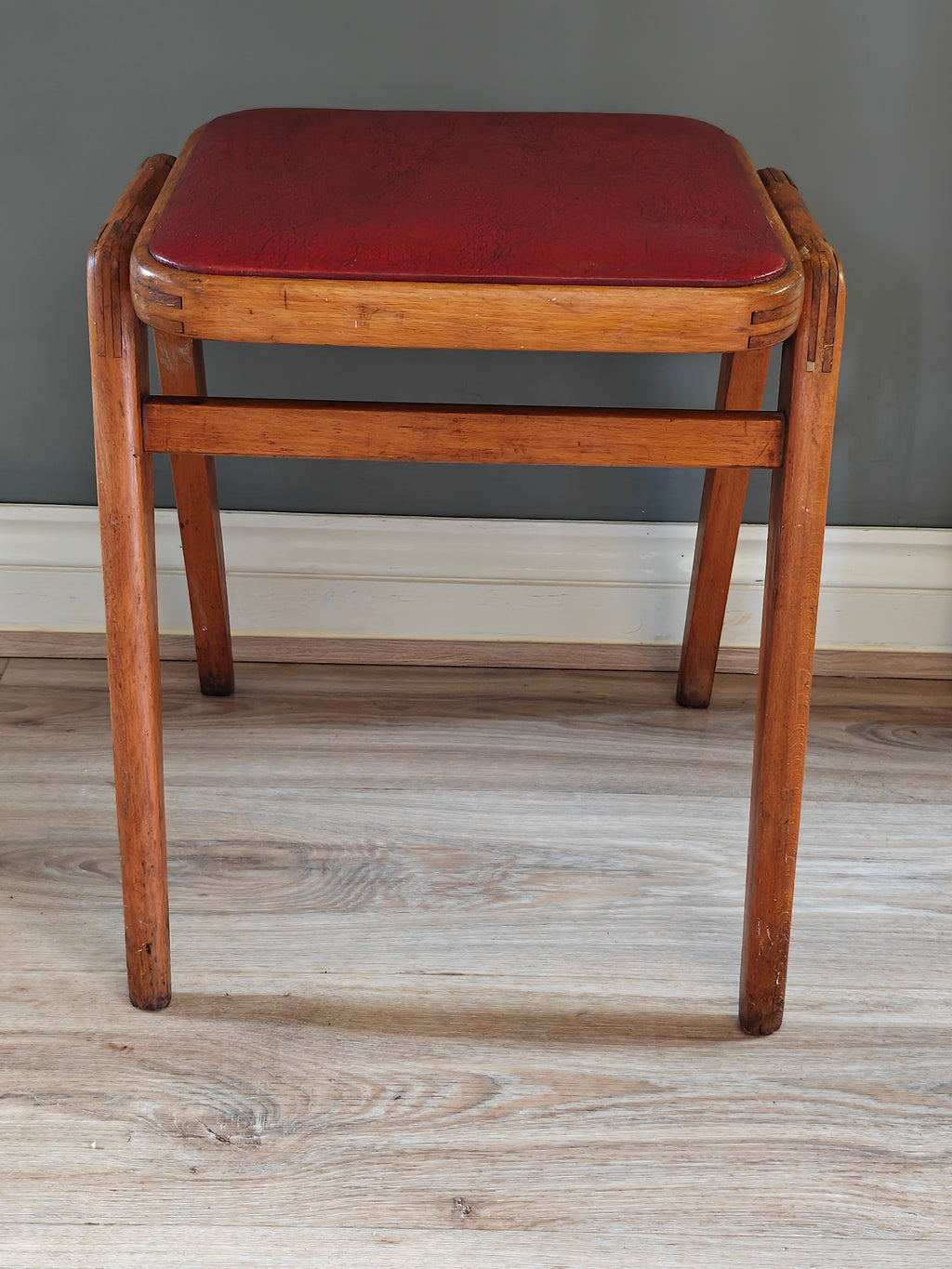 Mid-century wood frame stool with red vinyl seat
