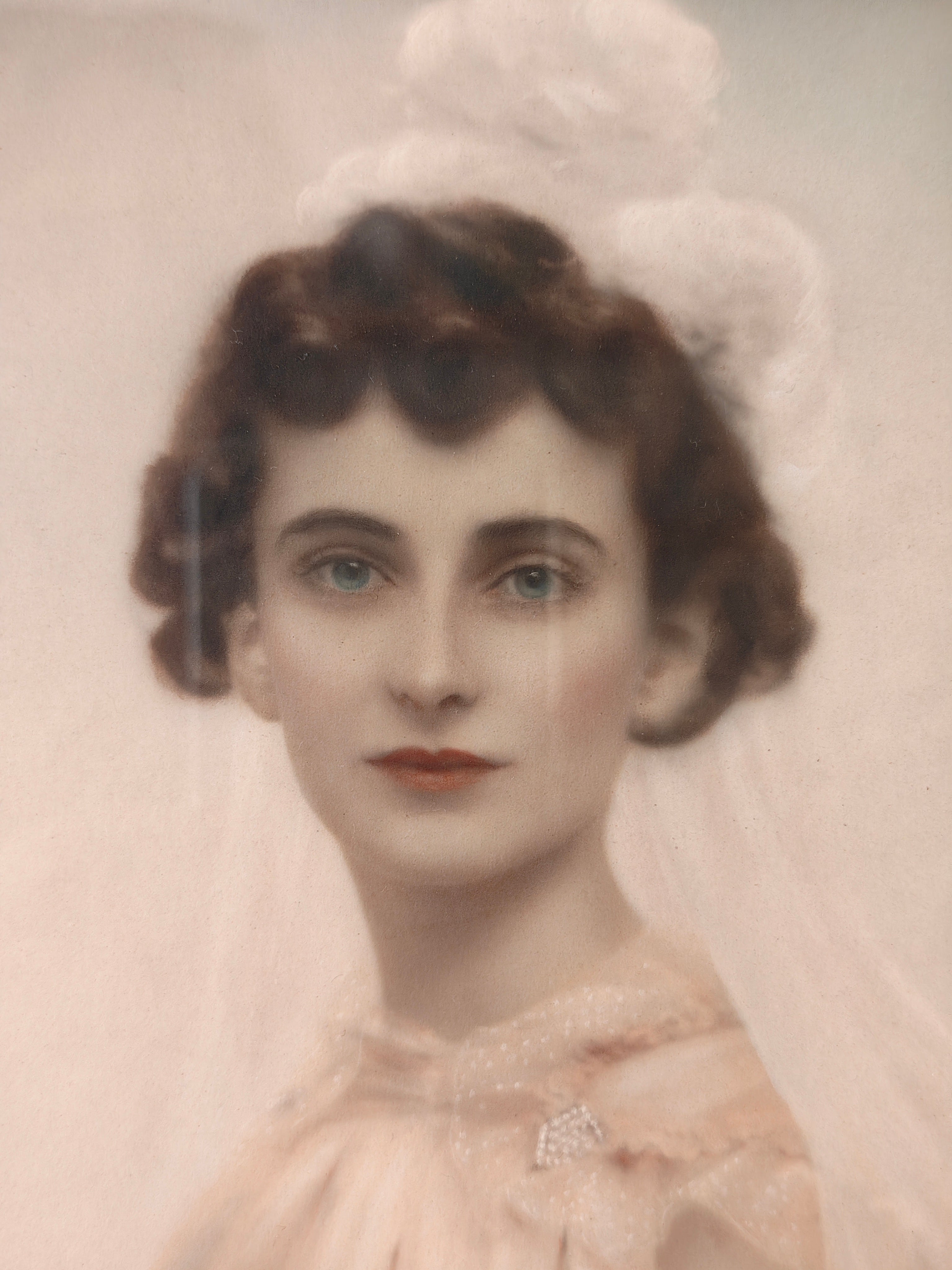 Close-up of vintage portrait print of a woman in a white bridal gown and veil.