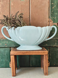A large pale blue mantle vase with fluted form and two handles
