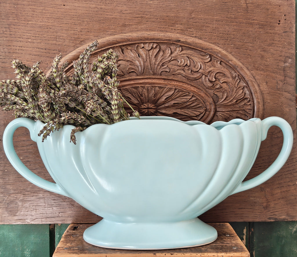 A large pale blue mantle vase with fluted form and two handles