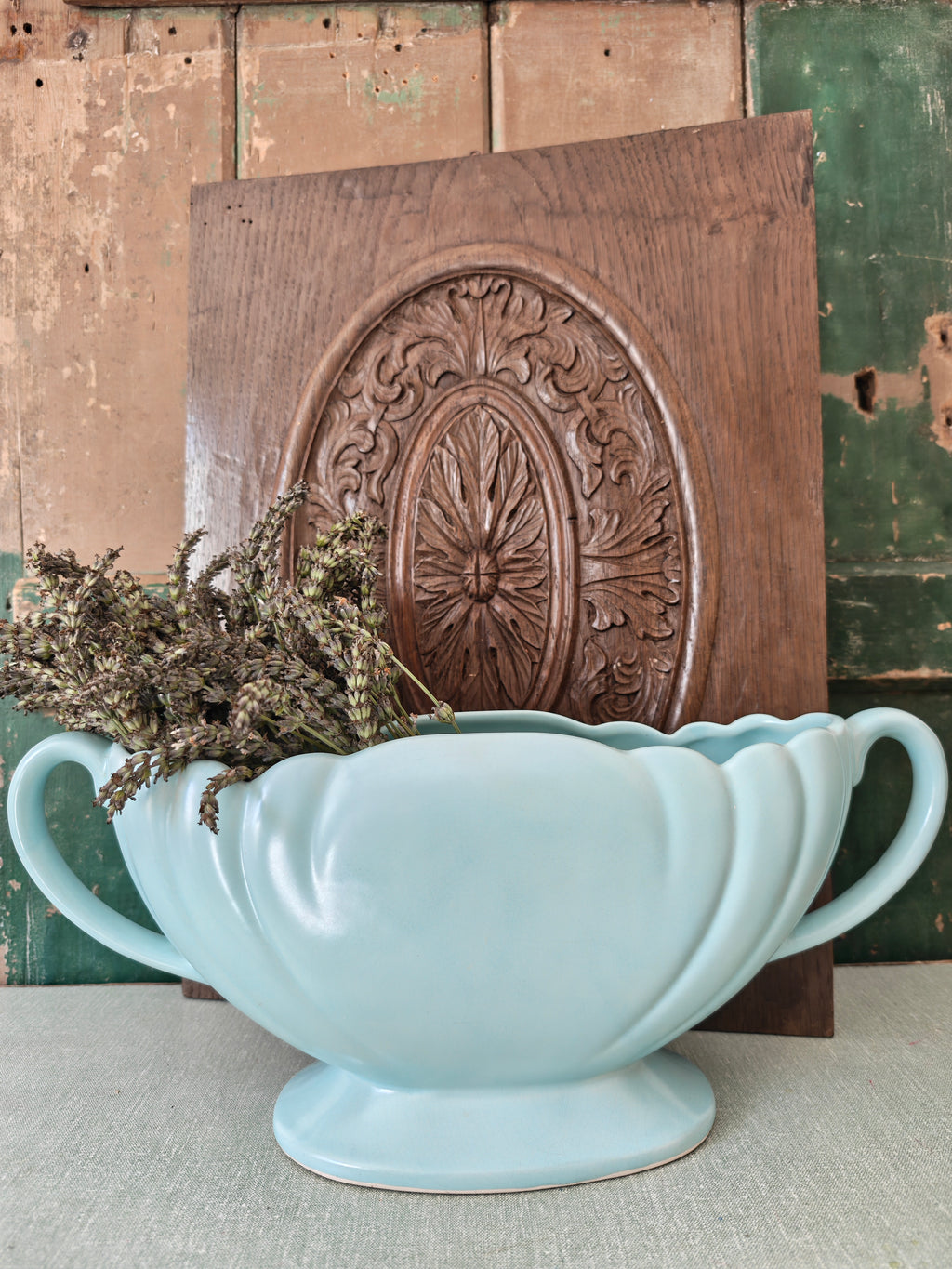 A large pale blue mantle vase with fluted form and two handles