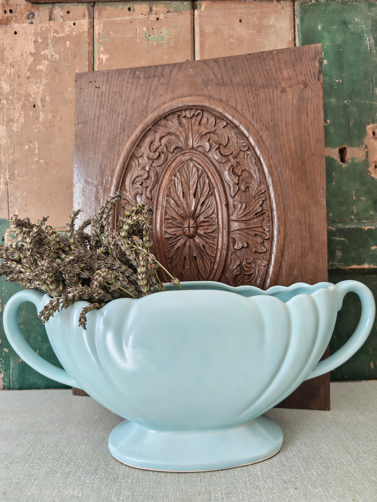 A large pale blue mantle vase with fluted form and two handles