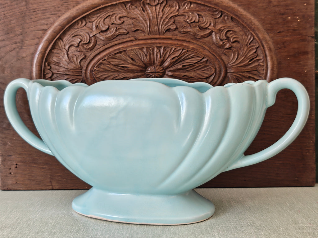 A large pale blue mantle vase with fluted form and two handles