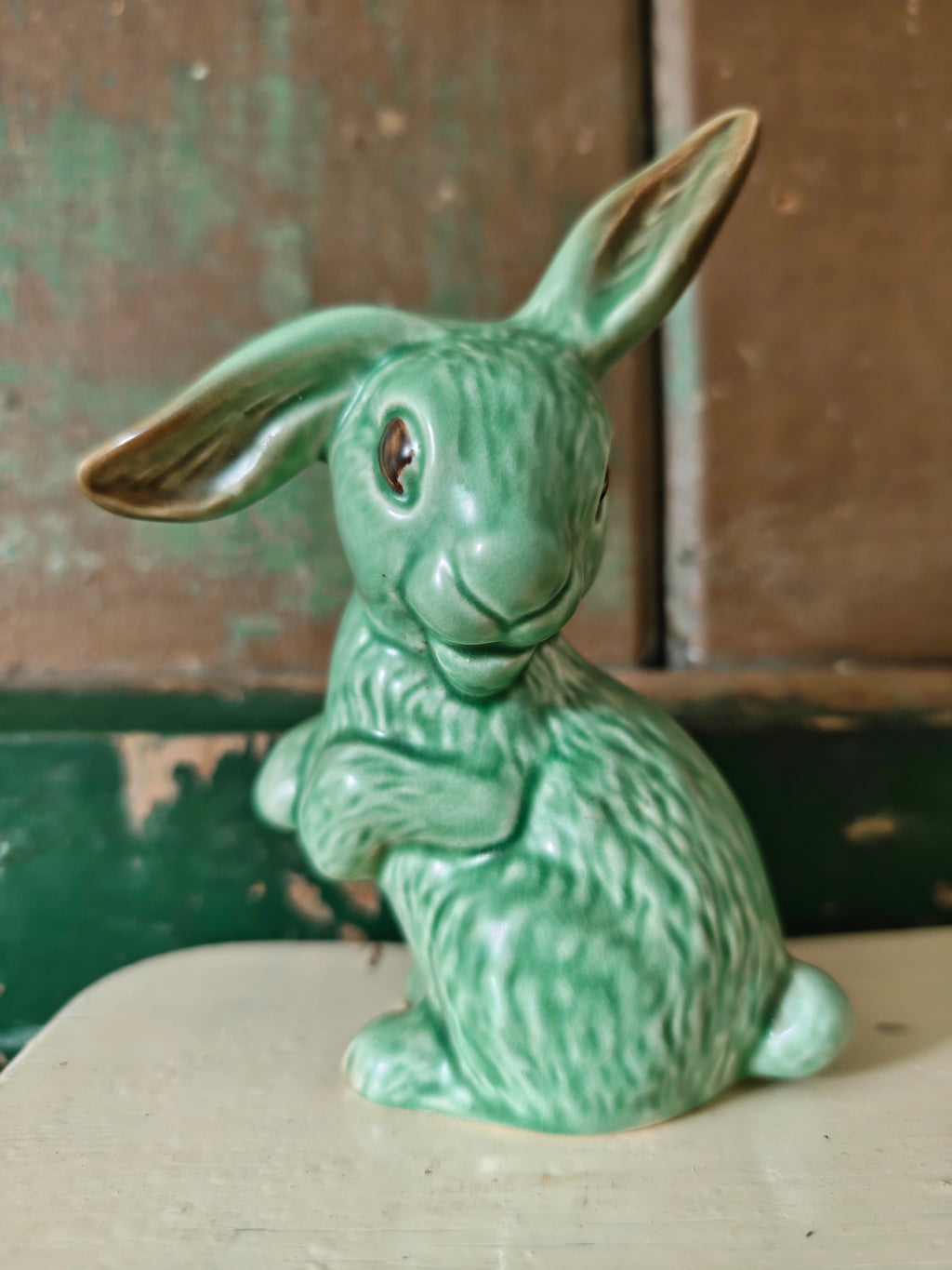 A green glazed ceramic rabbit figurine