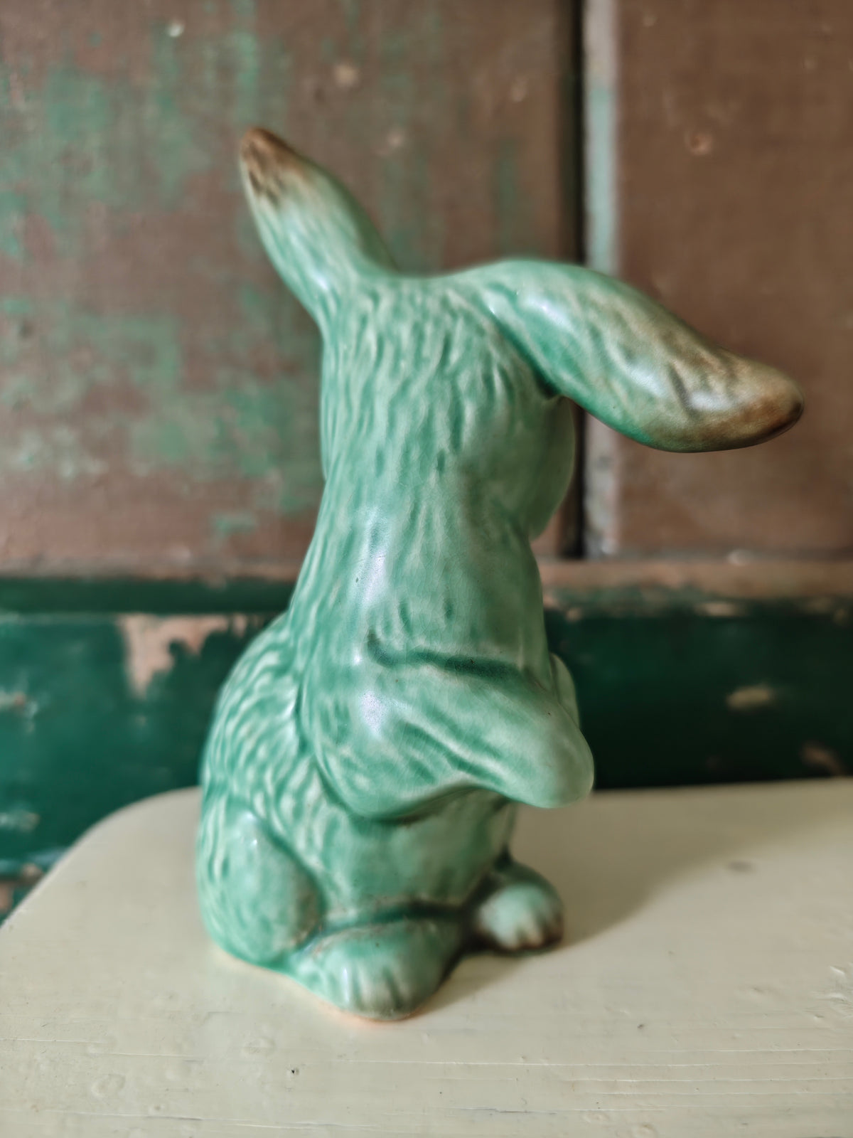 A green glazed ceramic rabbit figurine