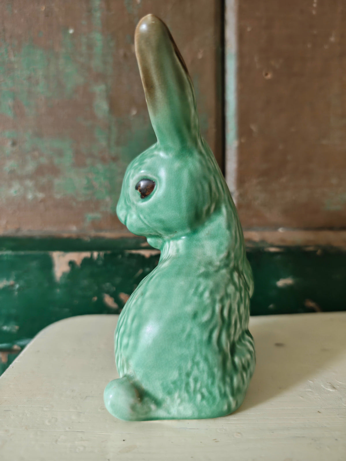 A green glazed ceramic rabbit figurine