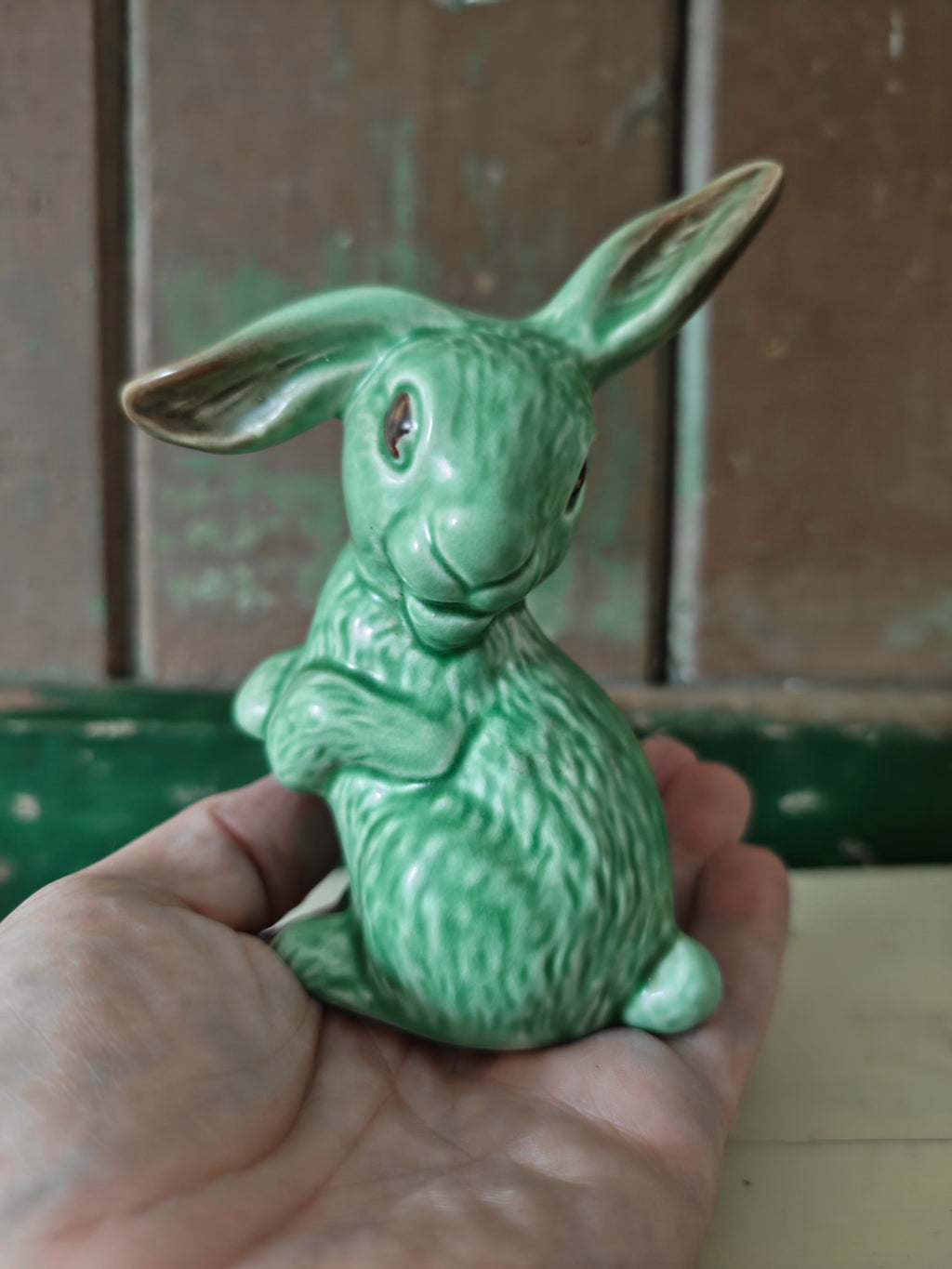 A green glazed ceramic rabbit figurine