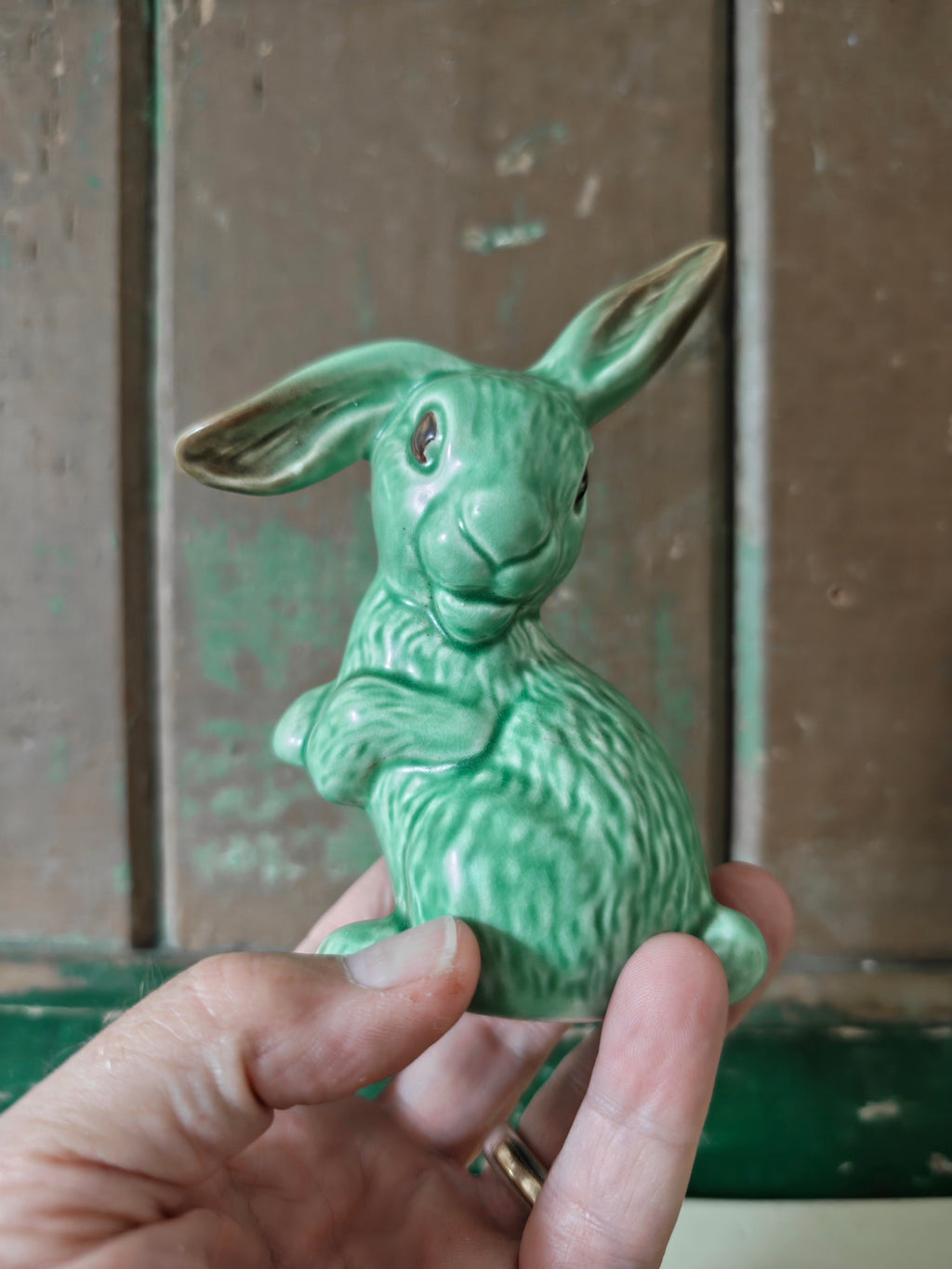A green glazed ceramic rabbit figurine