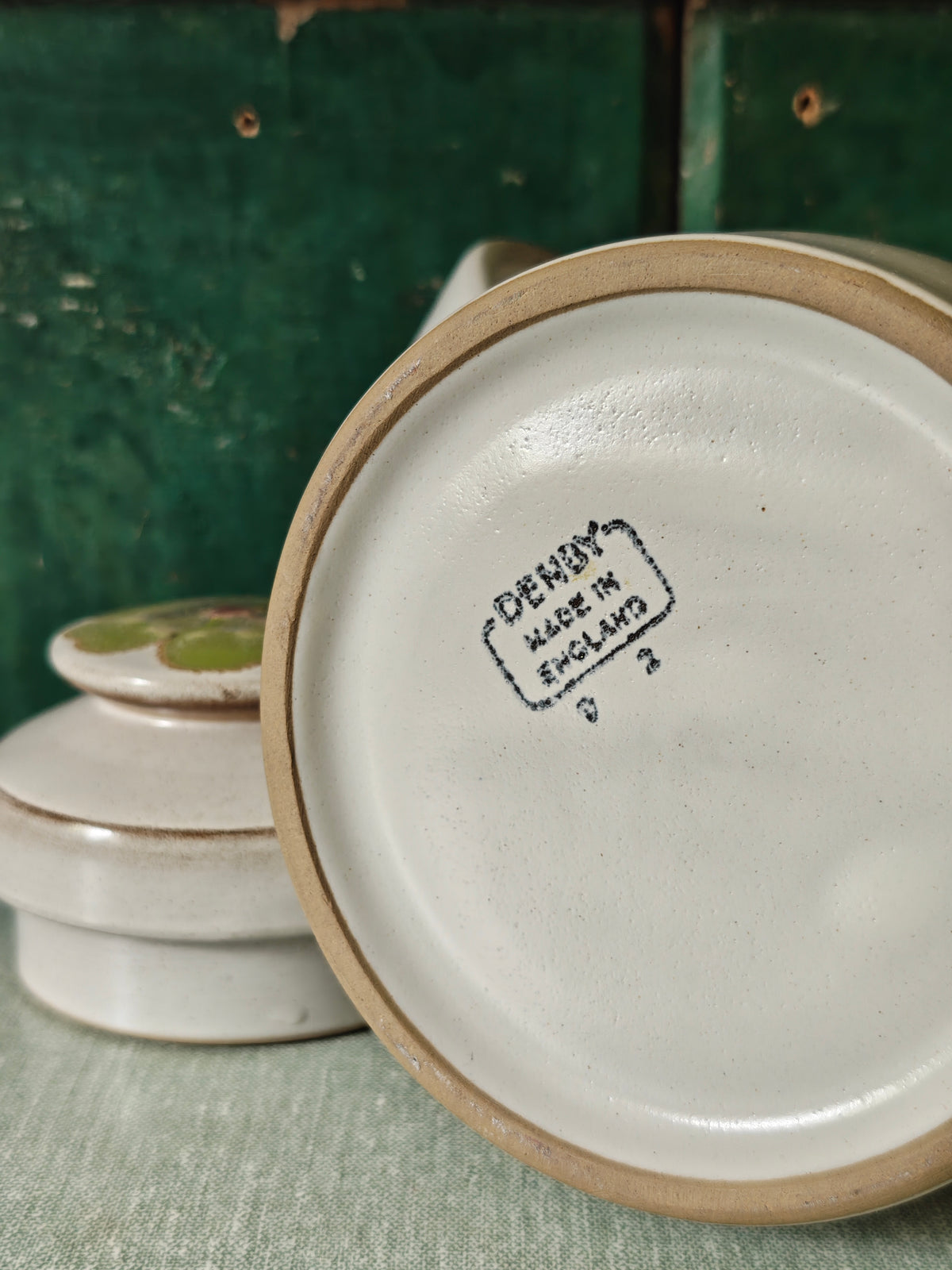 The base of a ceramic coffee pot showing Denby Made in England