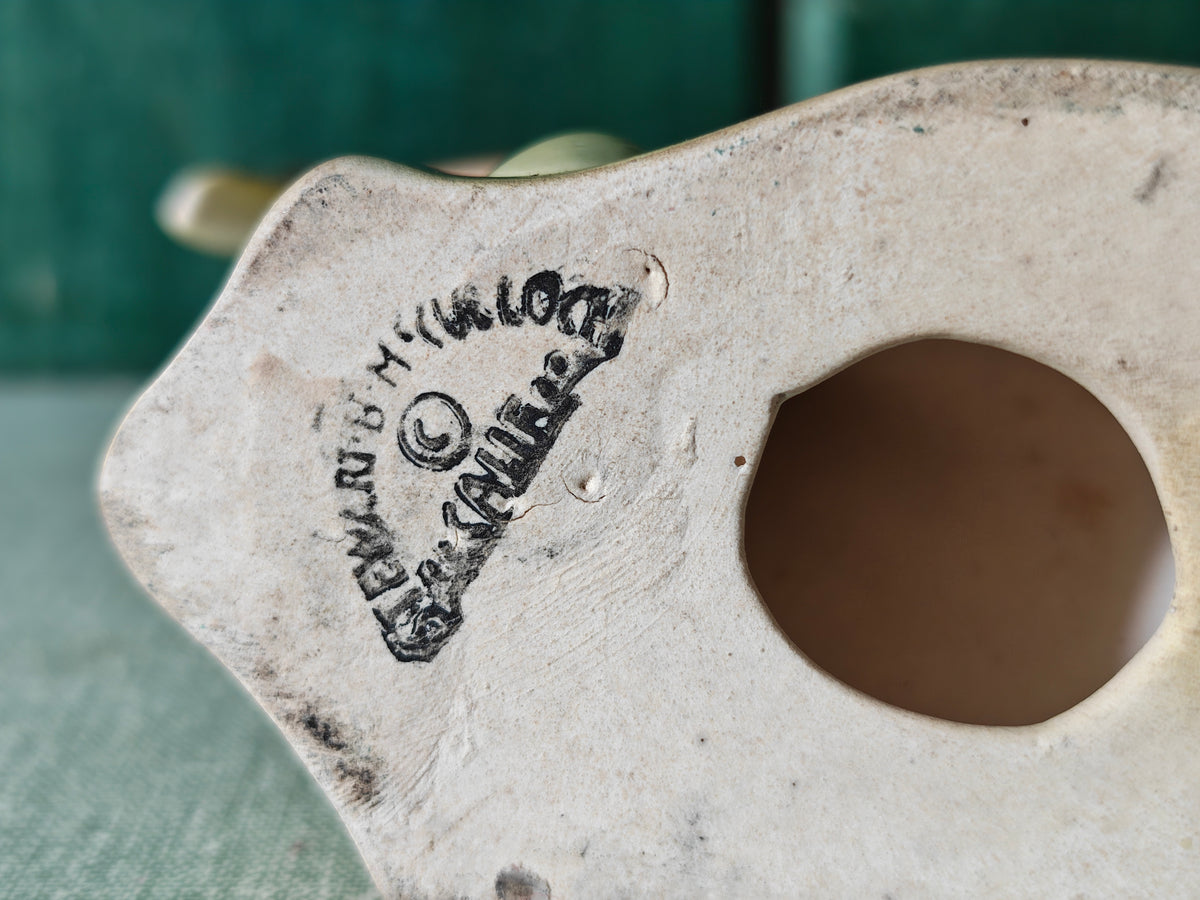 Base of a ceramic figurine showing the makers mark of Stewart McCulloch