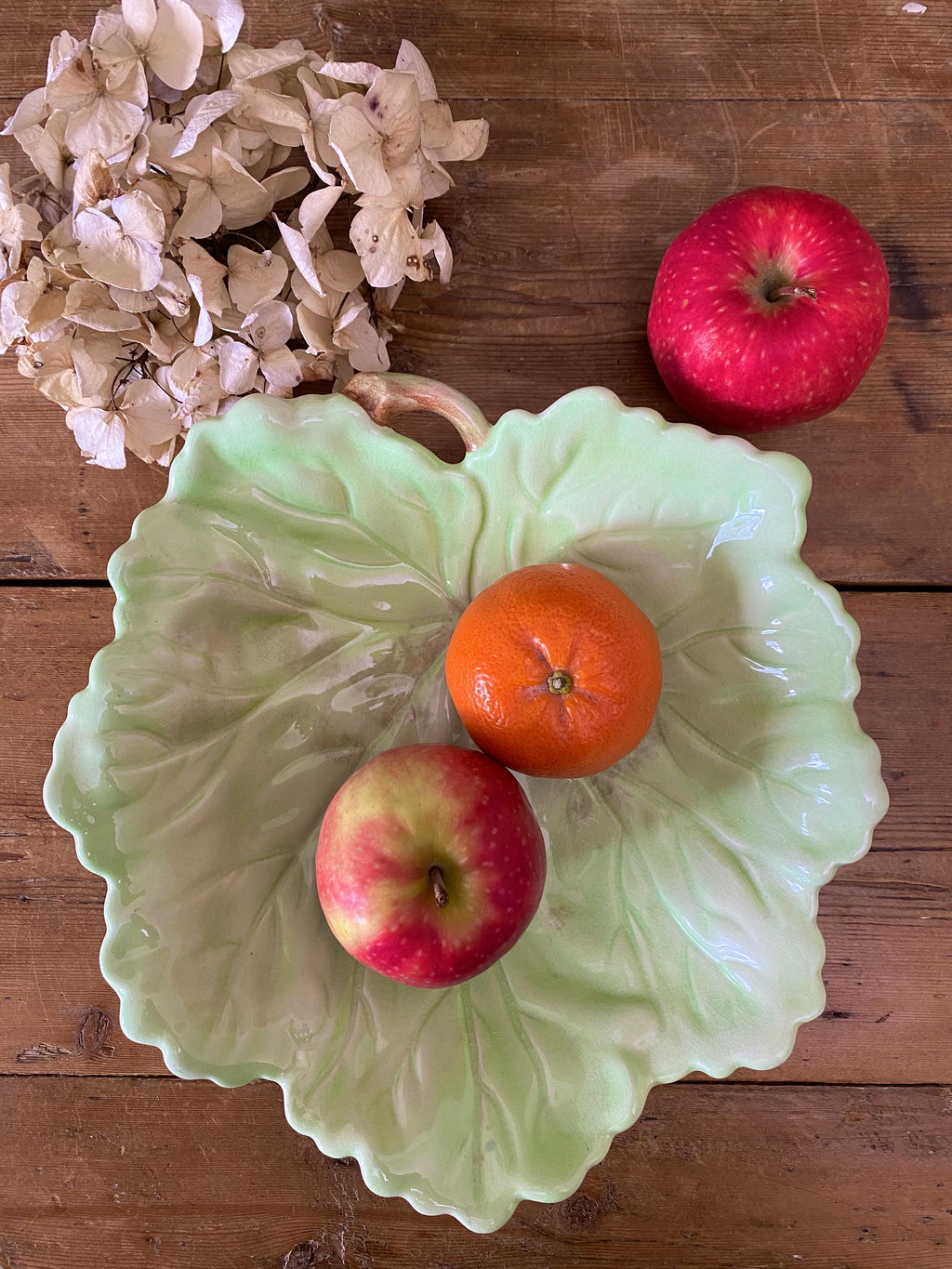 Decorative ceramic leaf-shaped dish displayed with fruit