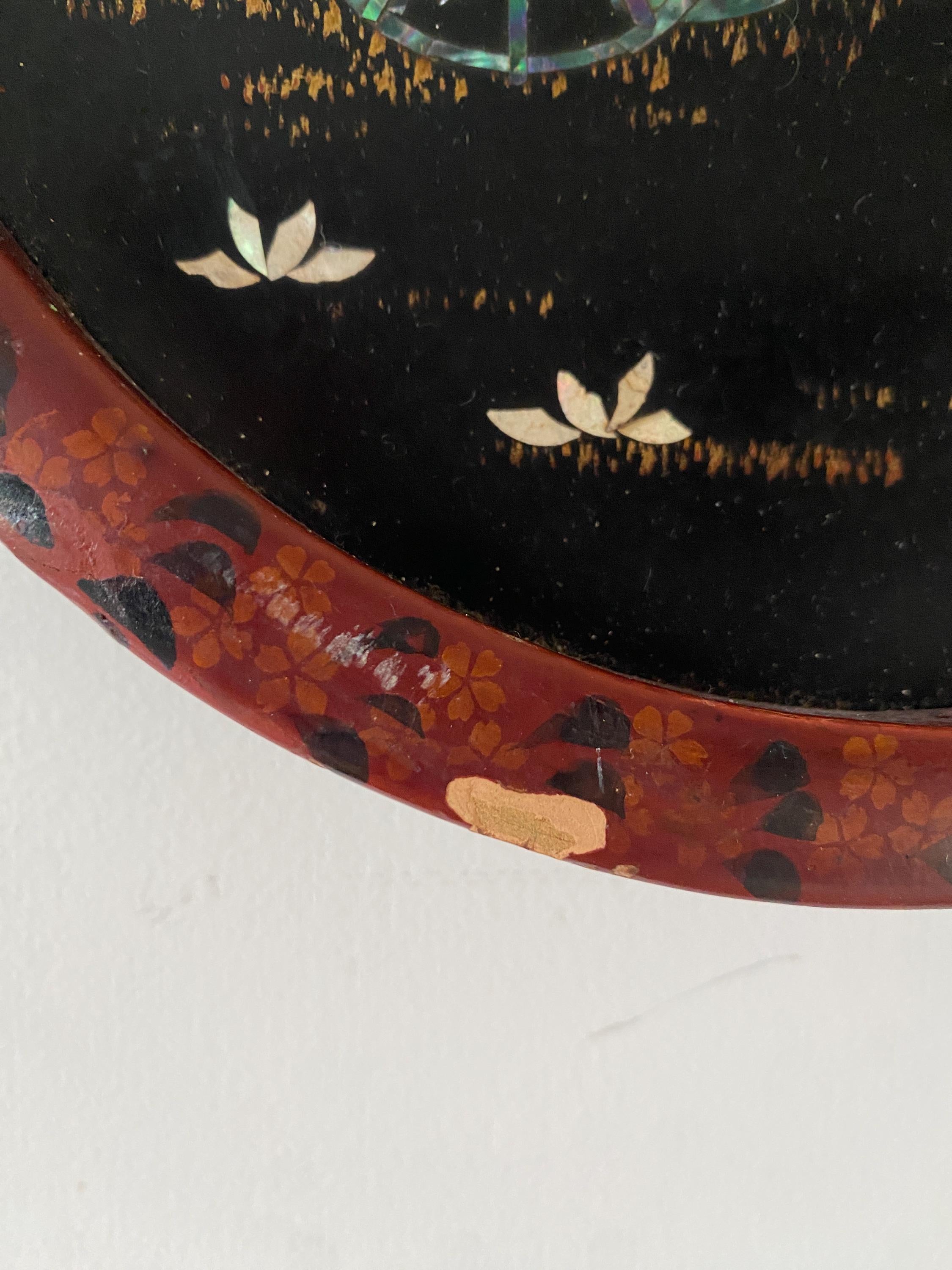 Close up of part of a hand painted wooden frame with floral decoration