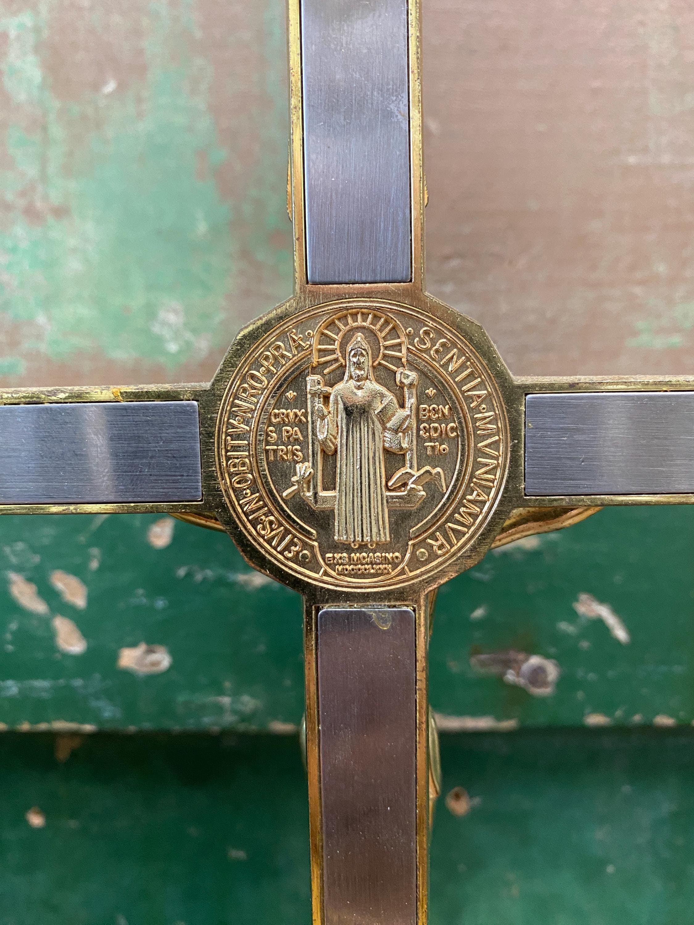 Gold and silver cross with religious emblem 