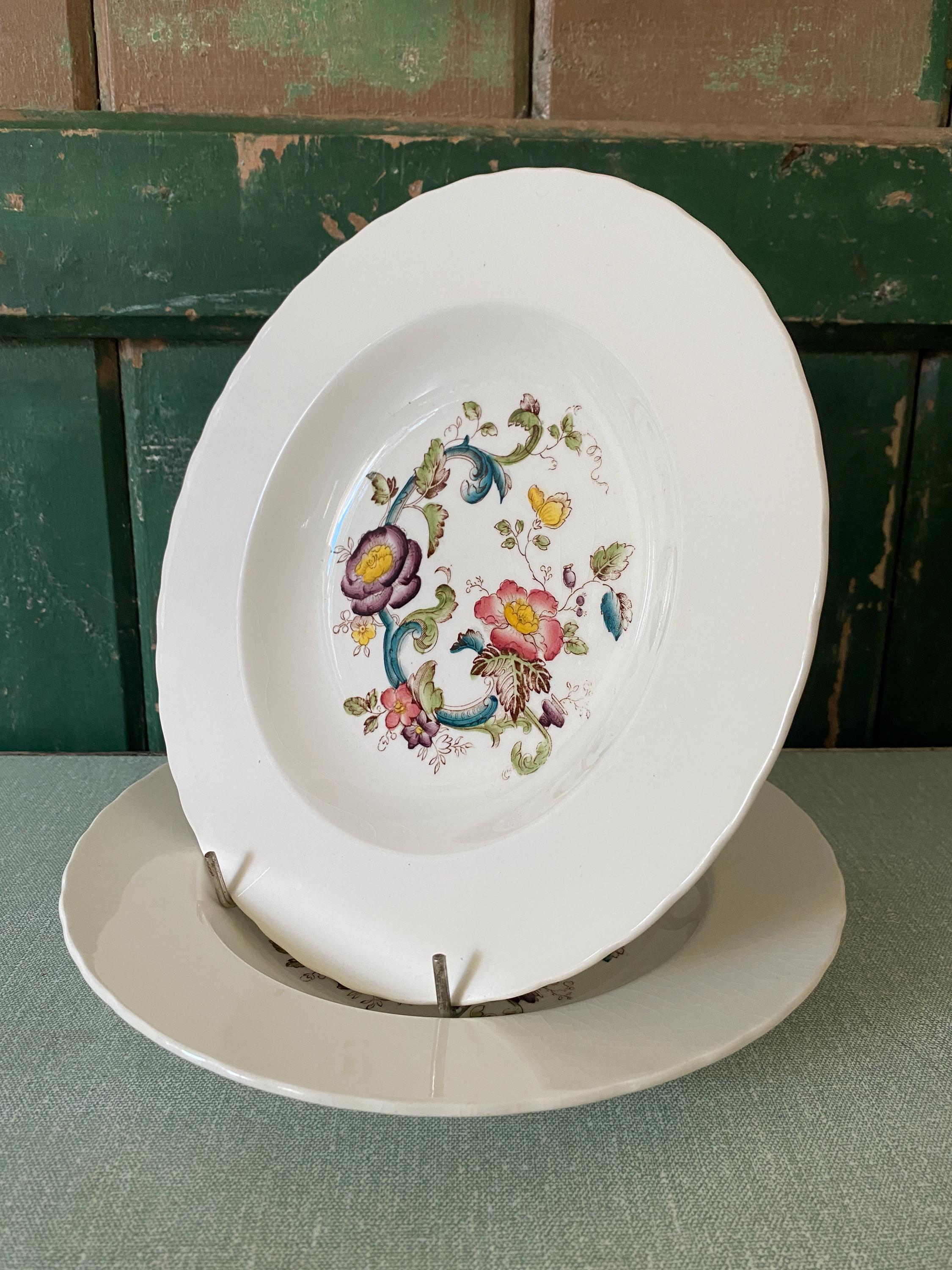 Two decorative ceramic plates with floral design 