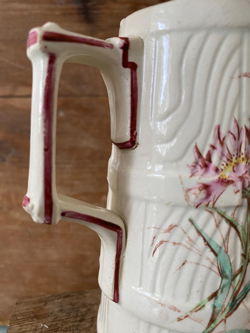 Close-up of a ceramic pitcher with floral design 