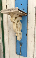 Rustic wooden shelf with decorative corbel and metal hook