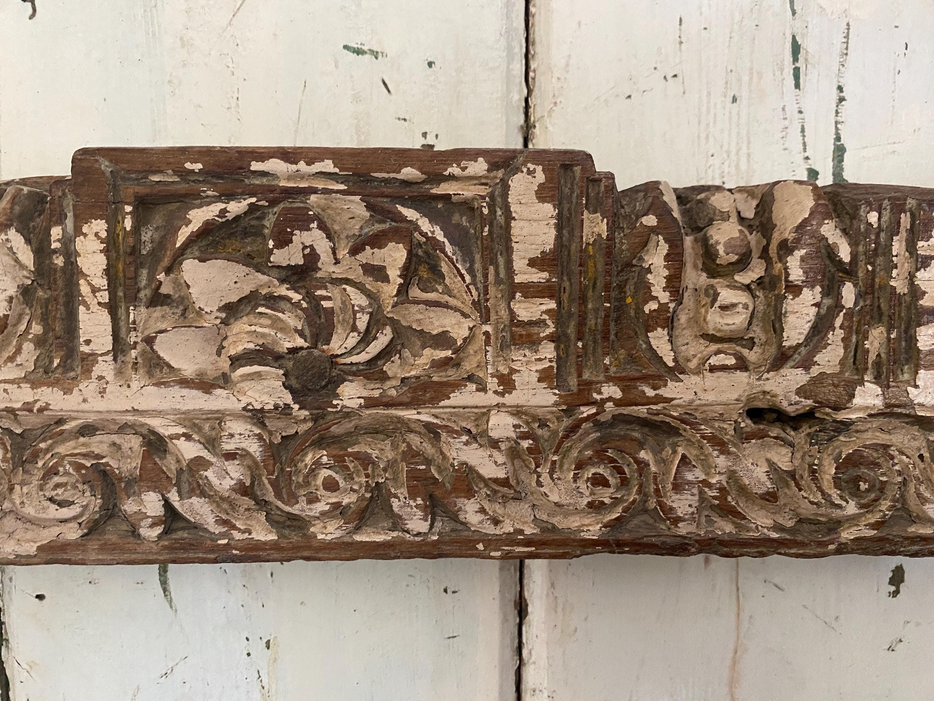 Decorative wooden panel with intricate carvings 