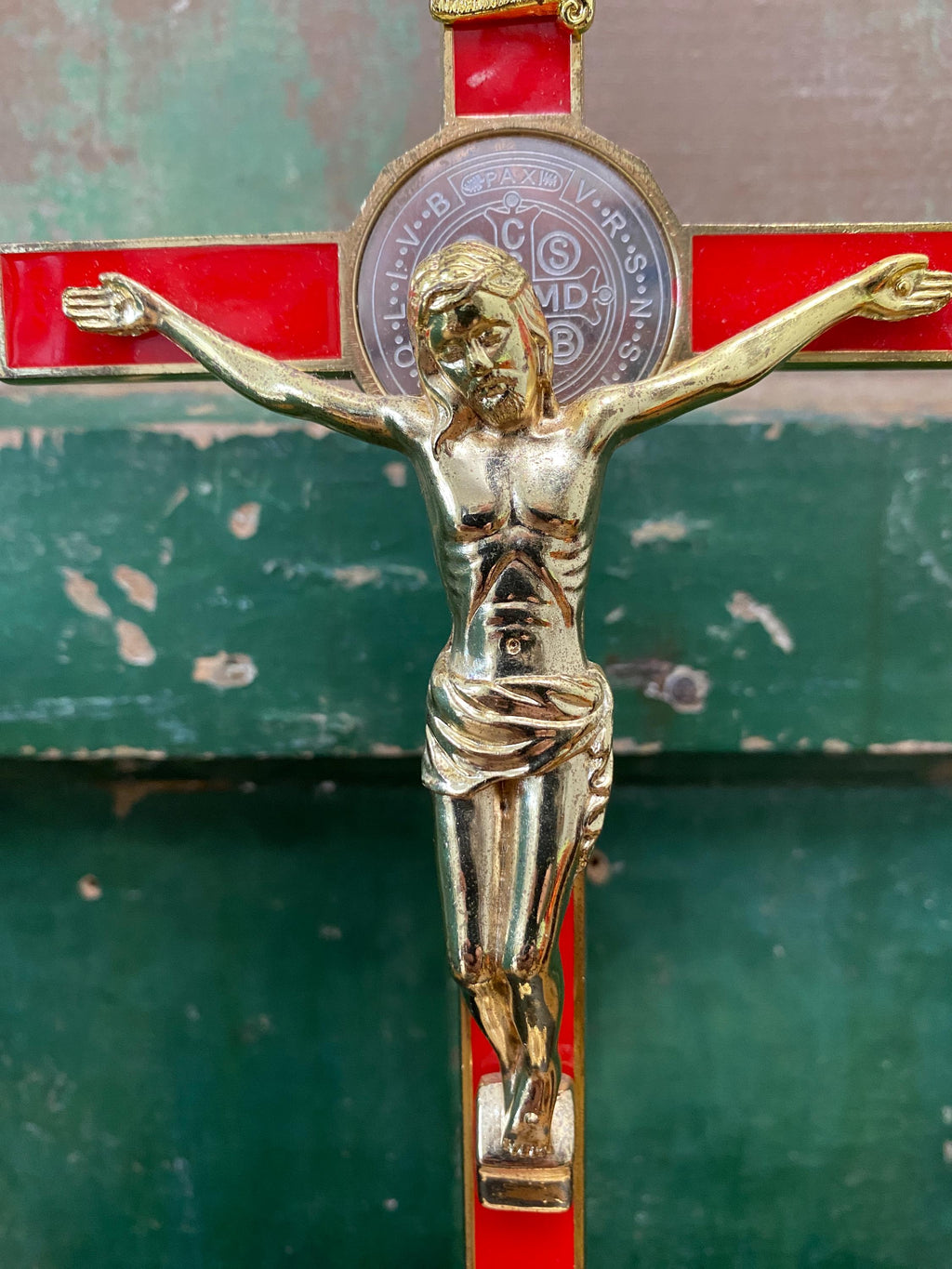 Close-up of a gold and red decorative crucifix