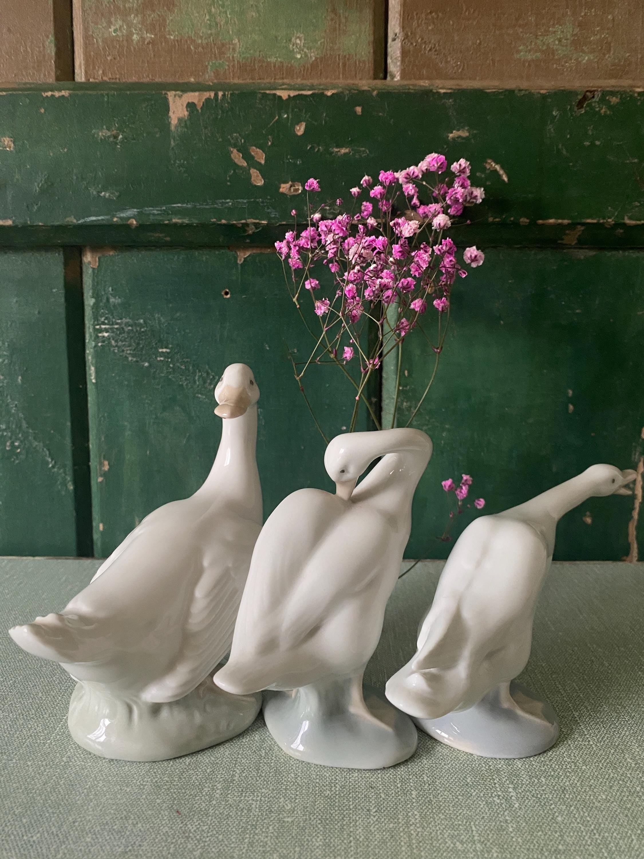 Three ceramic goose figurines 